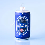 On a blue background is a glass ornament in the shape of a blue beer can with a silver loop at the top for hanging.