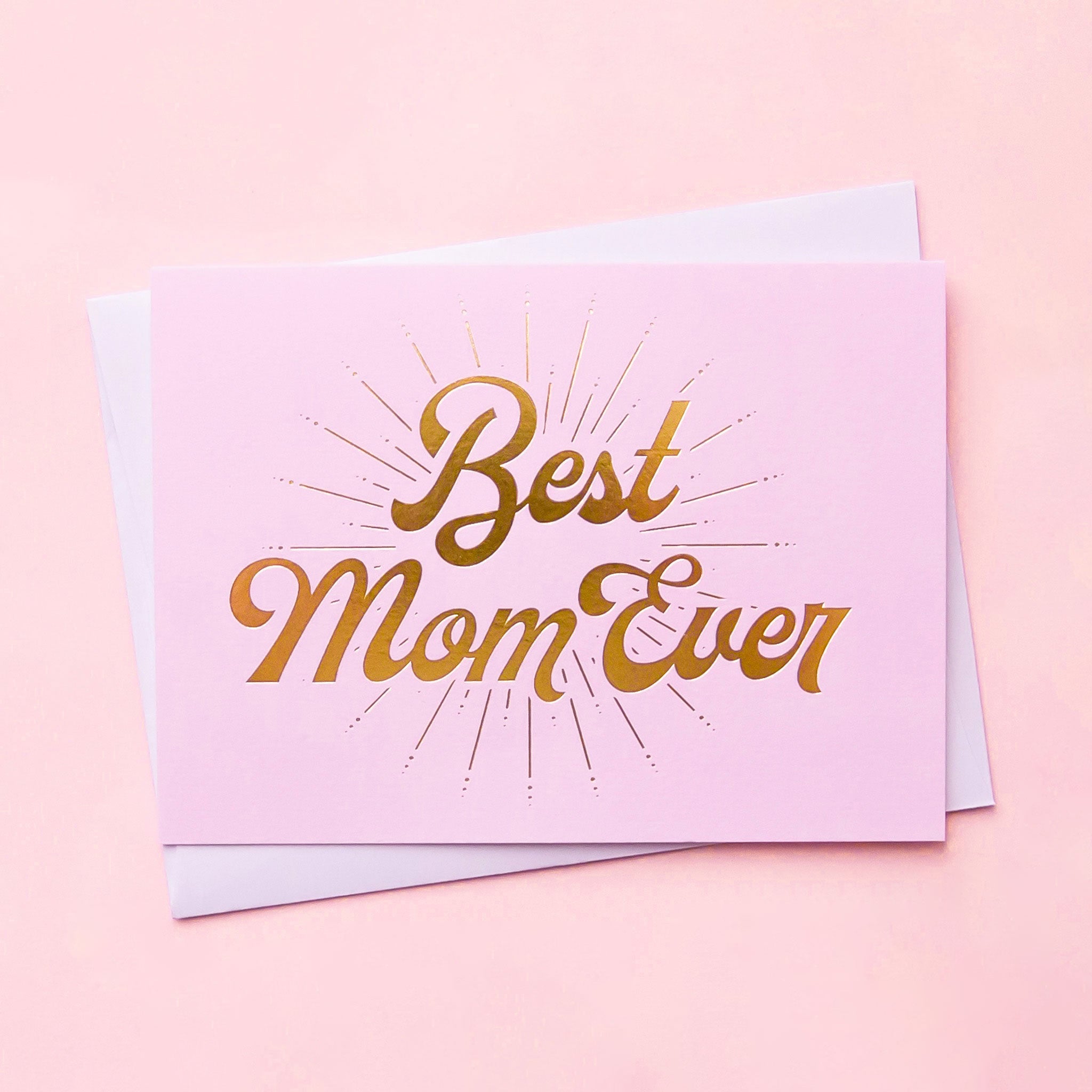 A lilac card with gold foiled letters that read, &quot;Best Mom Ever&quot; along with a white envelope.