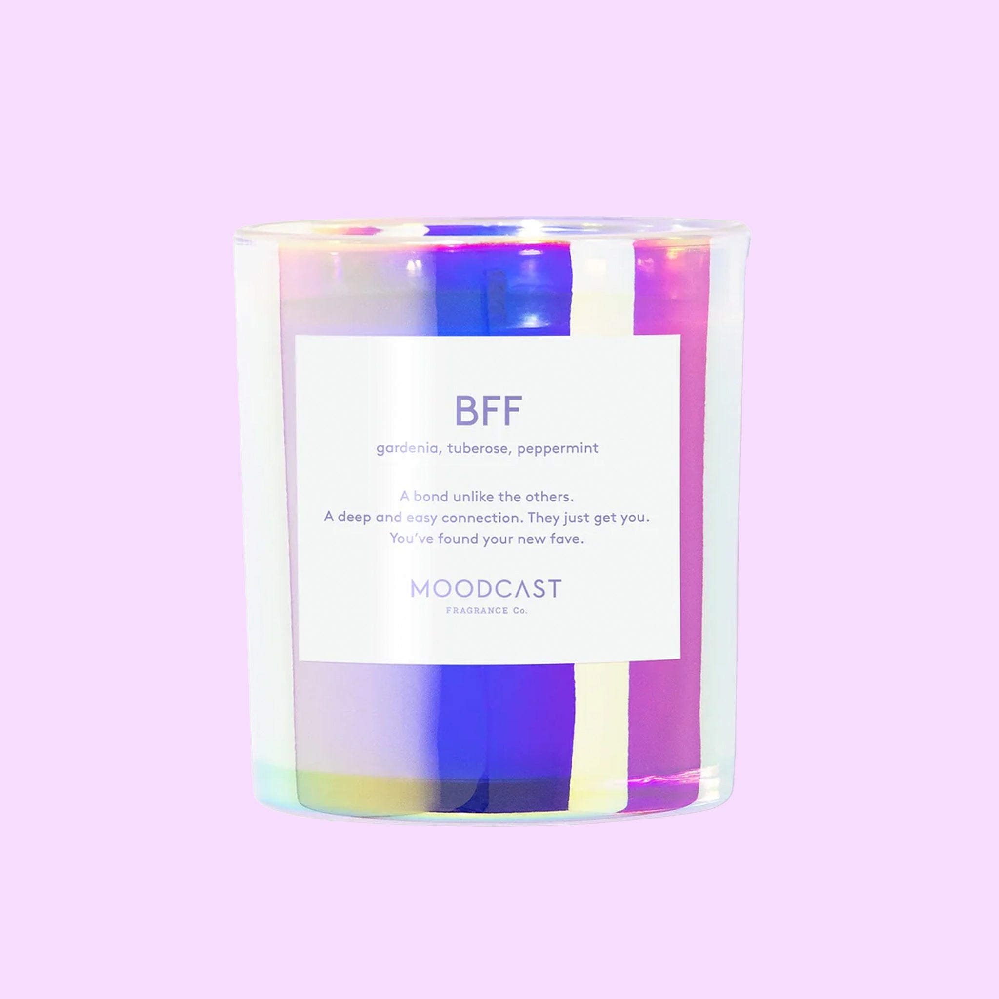 An iridescent glass jar candle with a label that reads, &quot;BFF&quot;. 