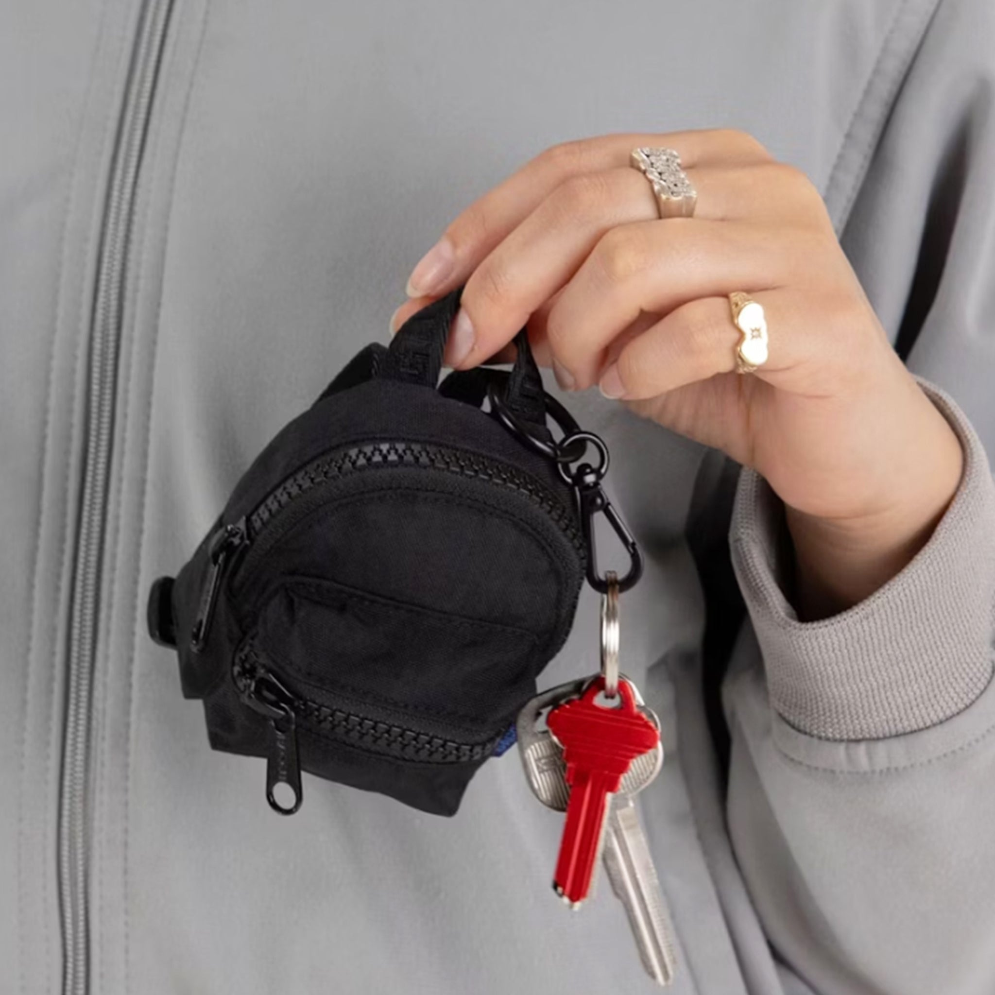 A black mini backpack bag charm. 