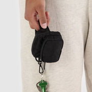 A black mini fanny pack shaped bag charm. 