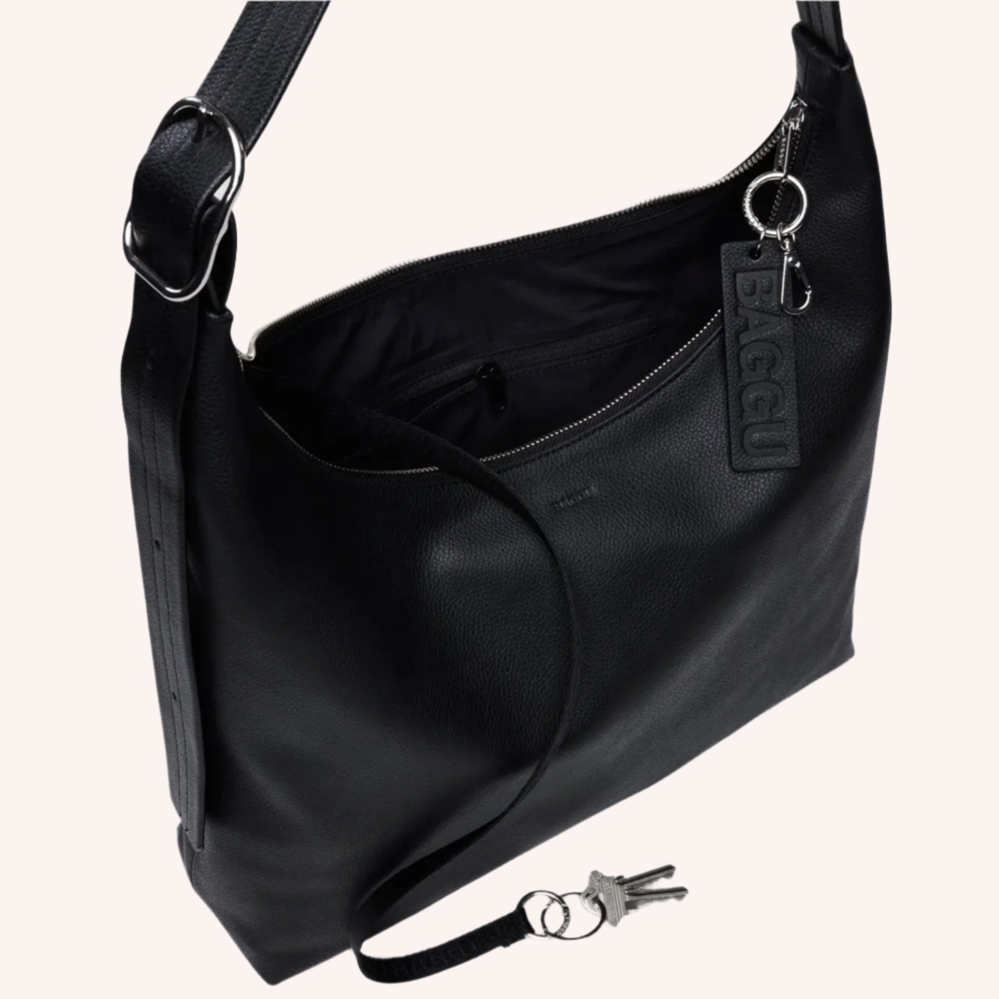 A black leather handbag with an adjustable strap. 