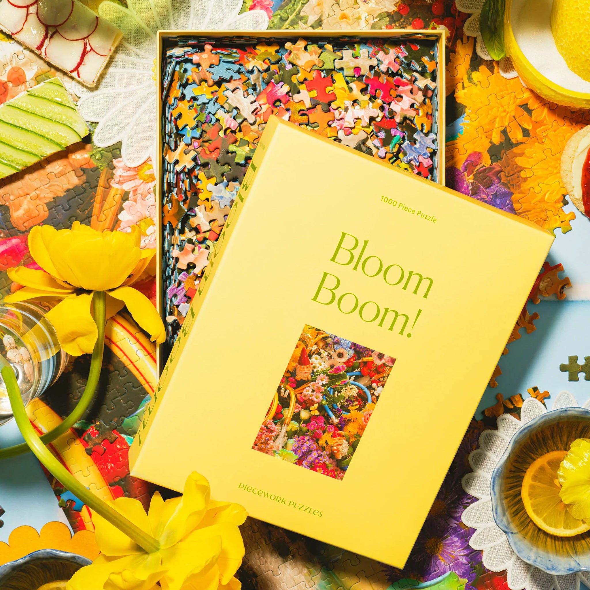 A yellow boxed puzzle with a floral print 1000 piece puzzle inside. 