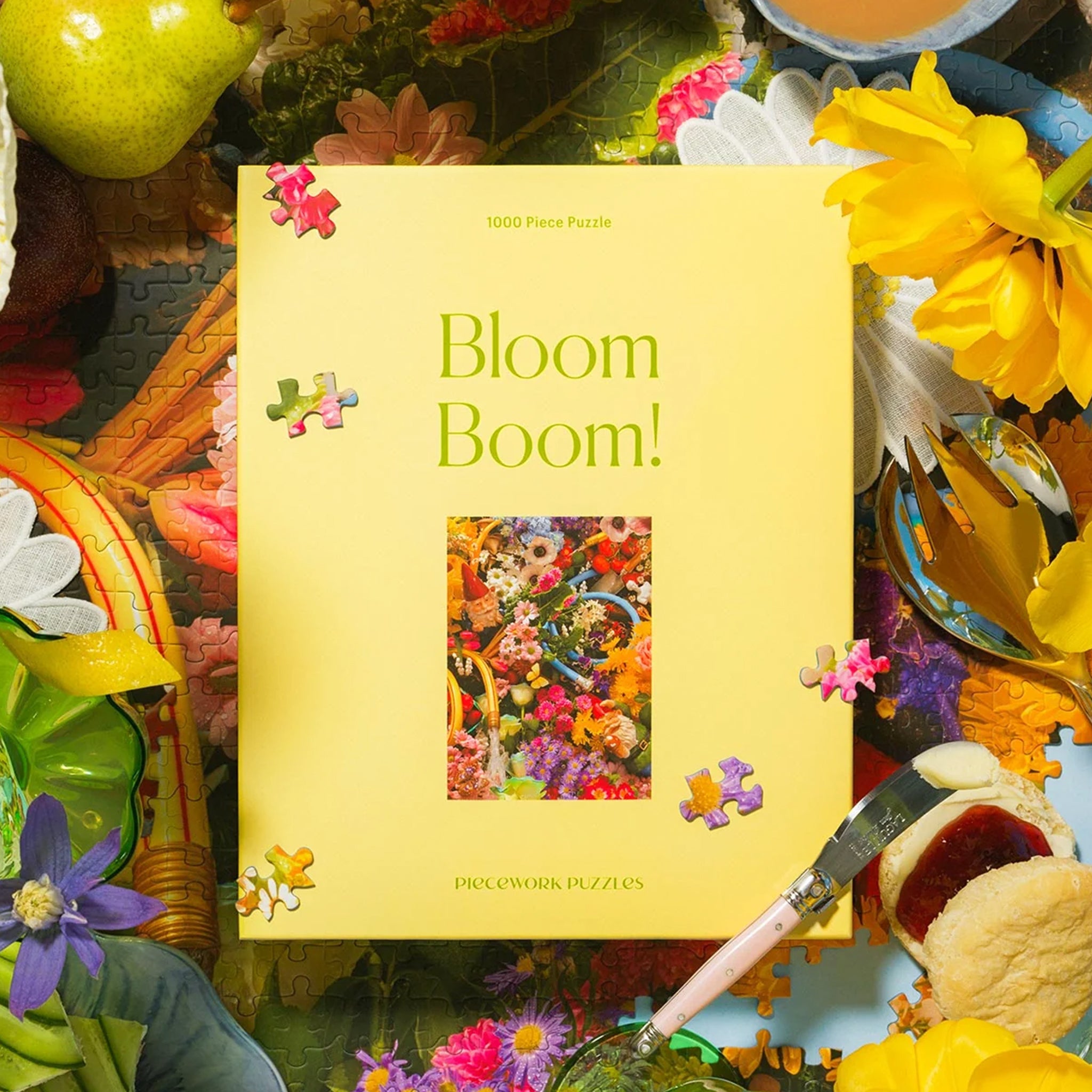 A yellow boxed puzzle with a floral print 1000 piece puzzle inside. 