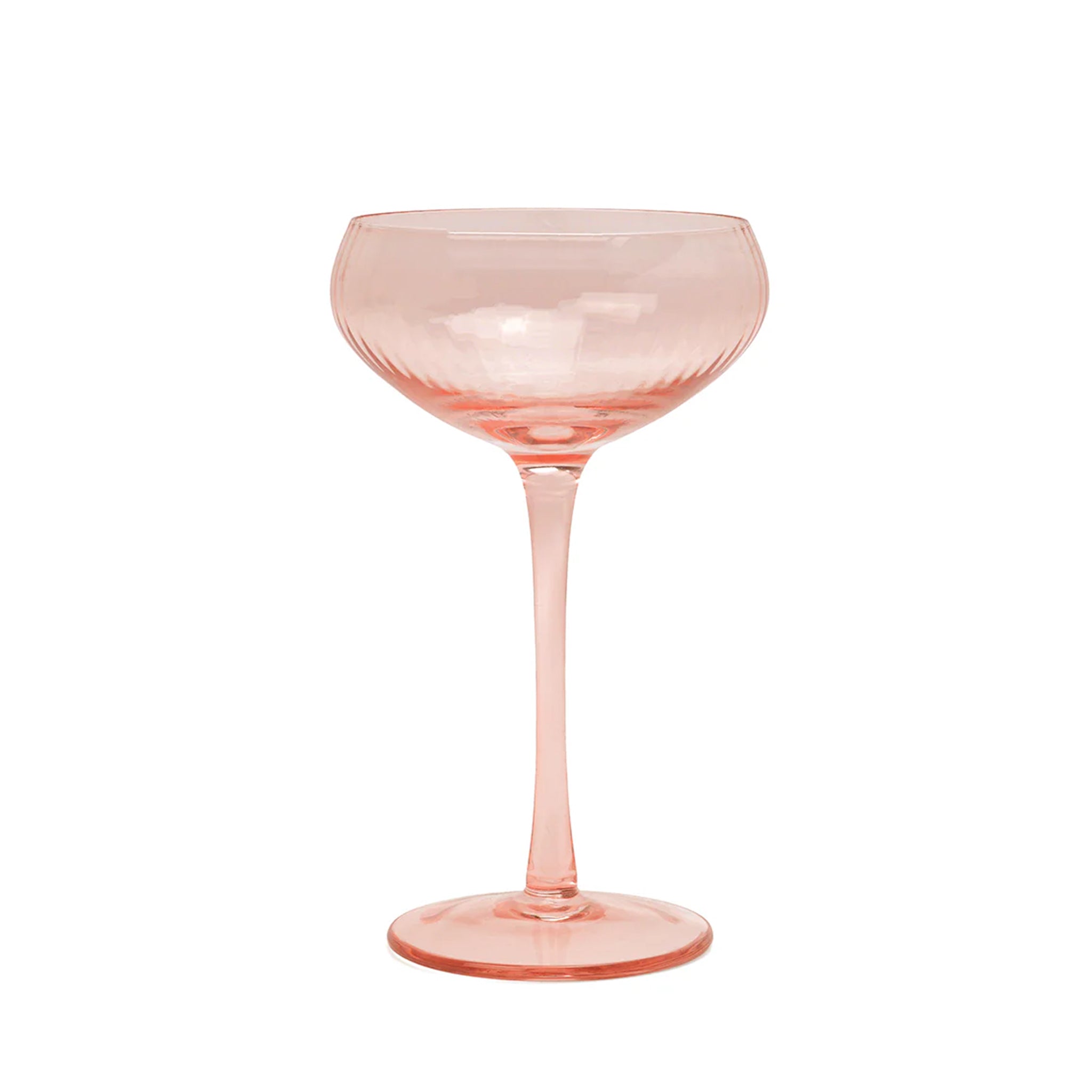 A blush pink coupe glass. 