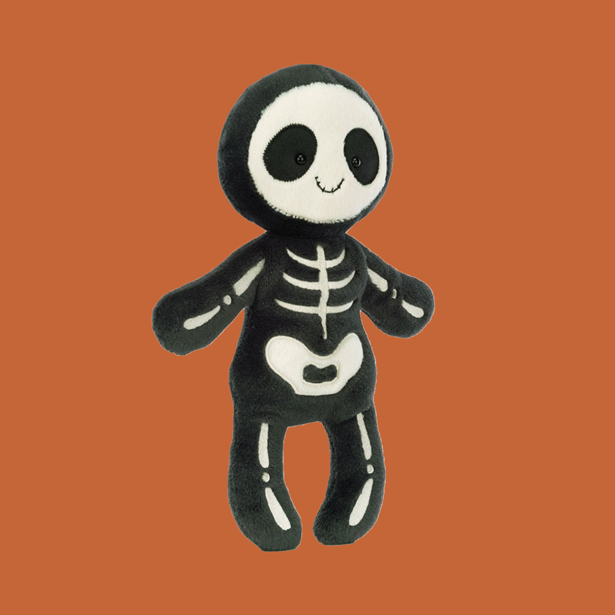 A black and white skeleton stuffed toy. 
