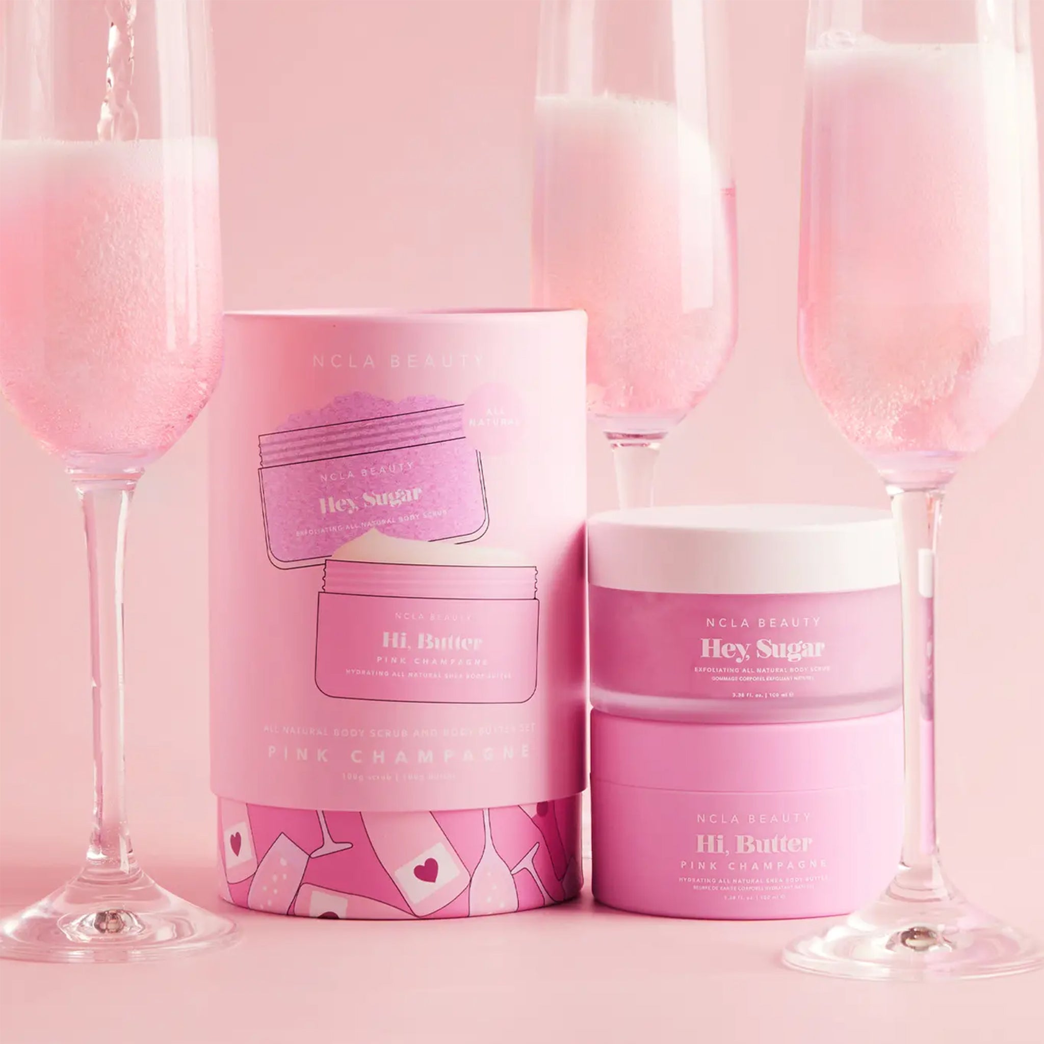 A set of a body butter and a body scrub with a pink champagne scent. 