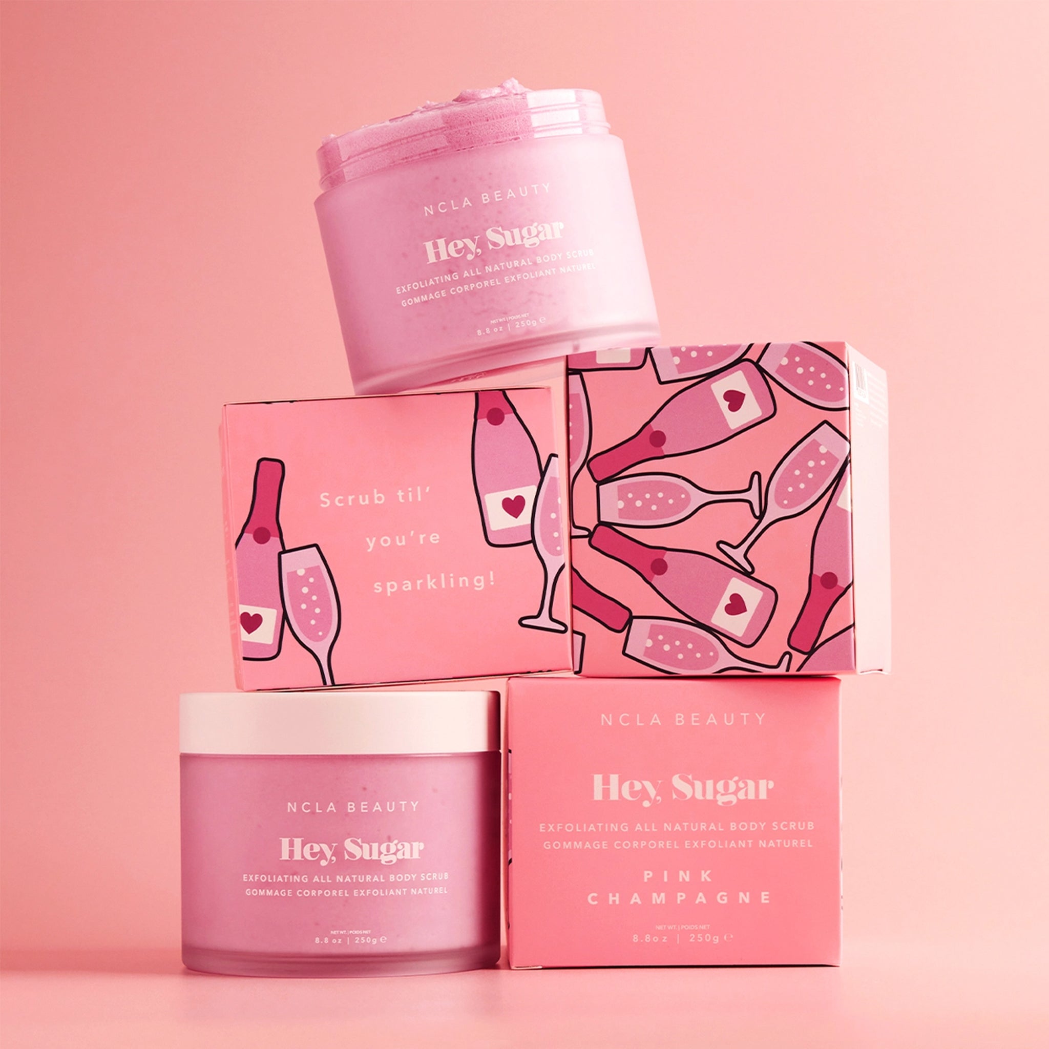 A pink container of sugar body scrub. 