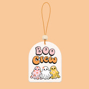 A white arch shaped air freshener with three ghost designs and text that reads, "Boo Crew". 