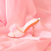 A glass mule heel shaped ornament with a pink fuzzy detail. 