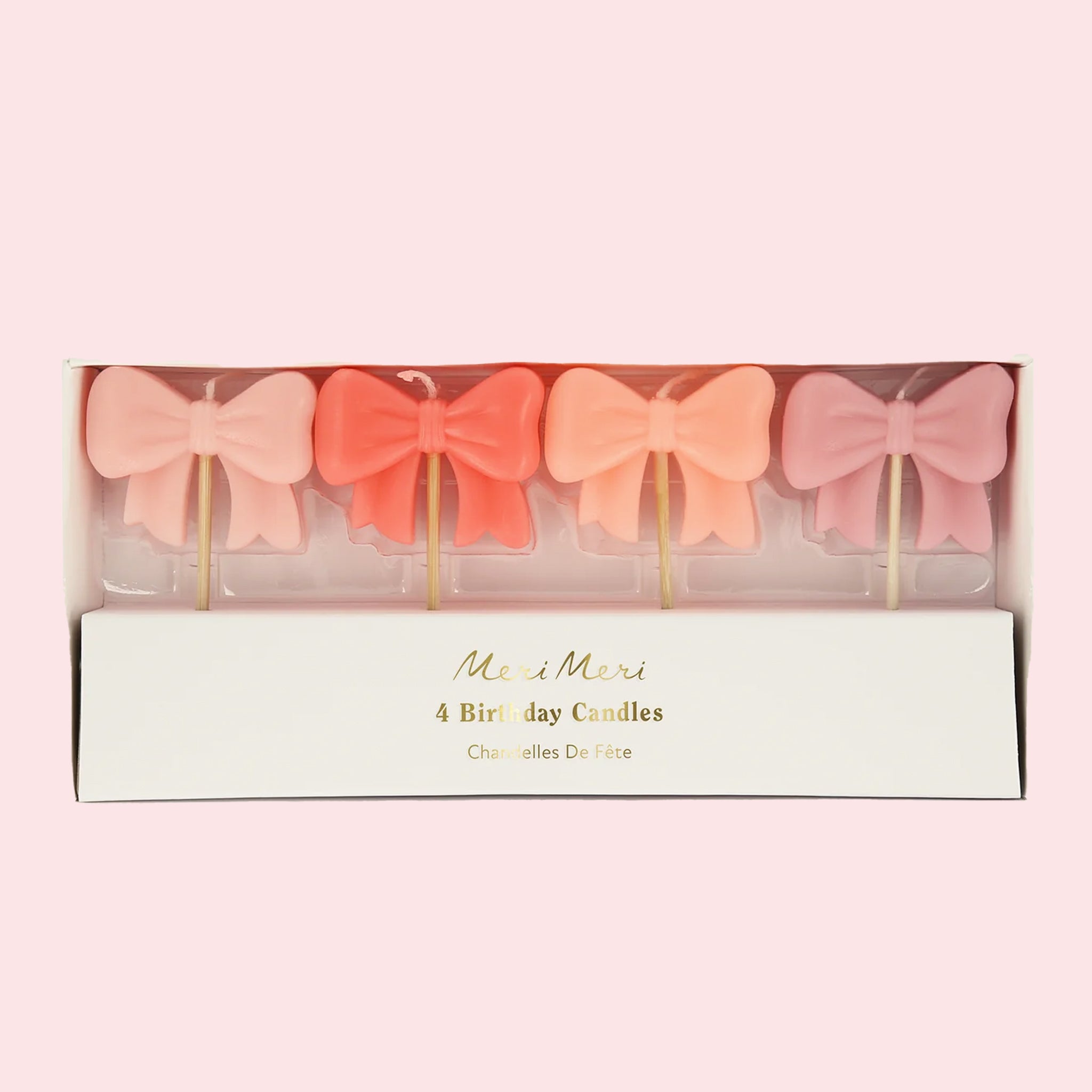 A set of four bow shaped birthday candles.