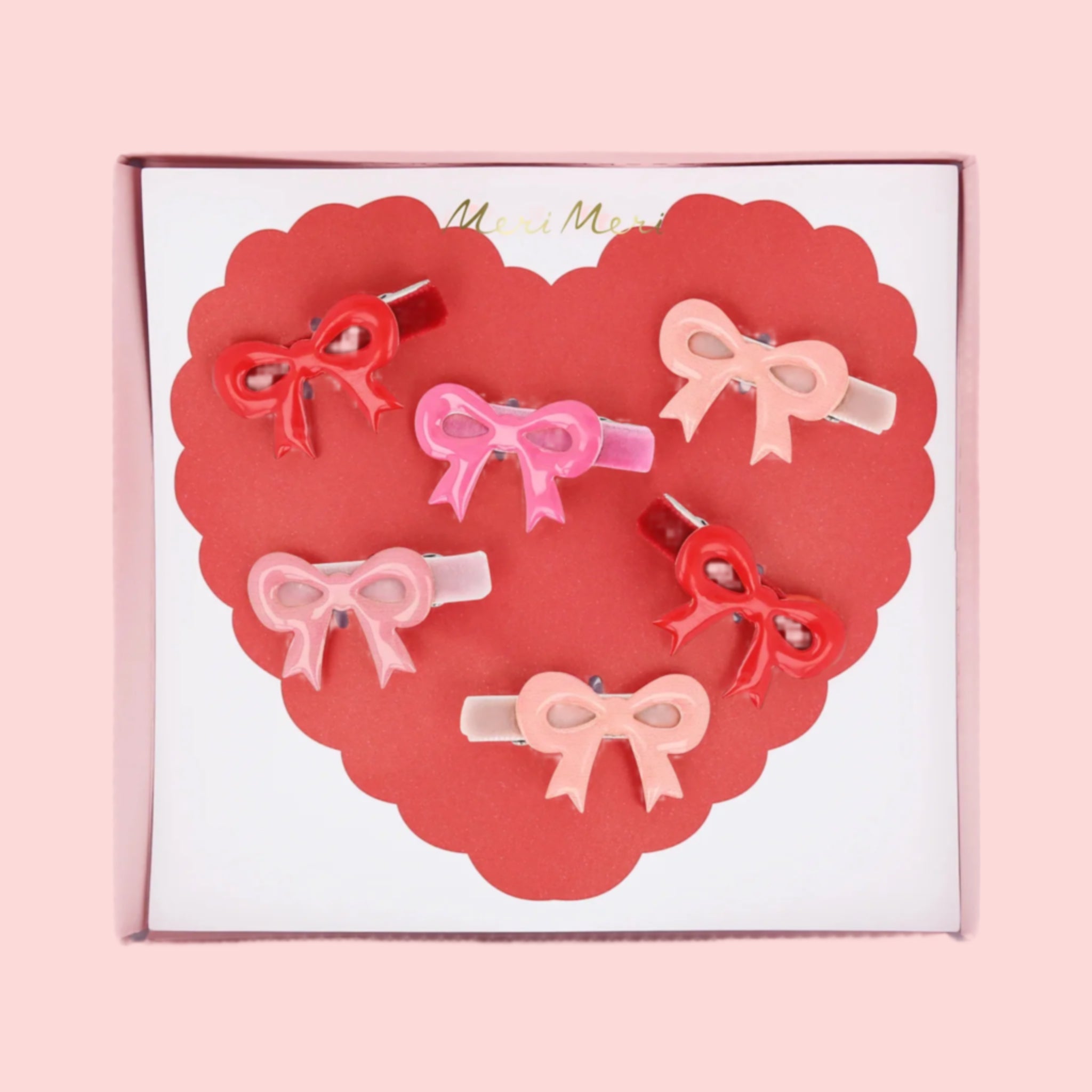 A pack of pink and red enamel bows. 