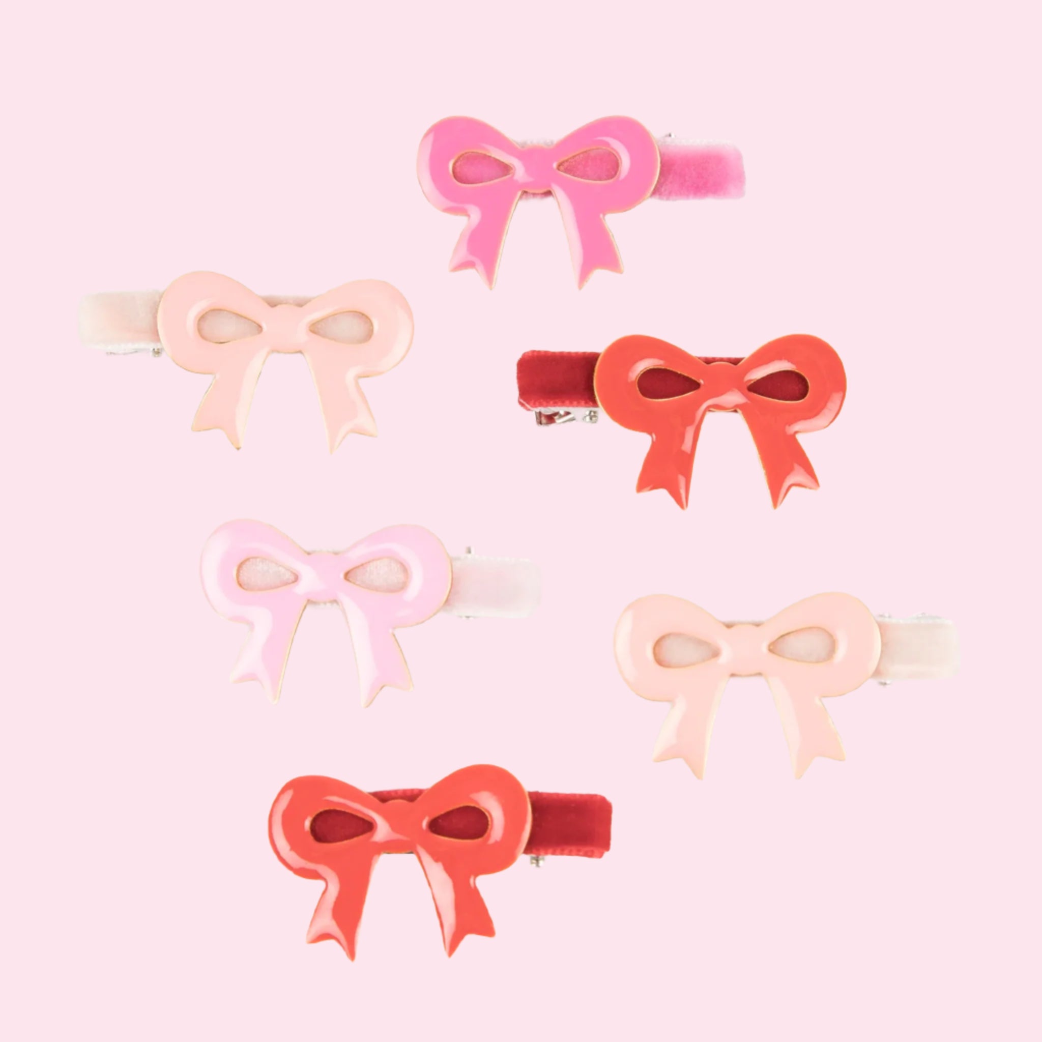 A pack of pink and red enamel bows. 