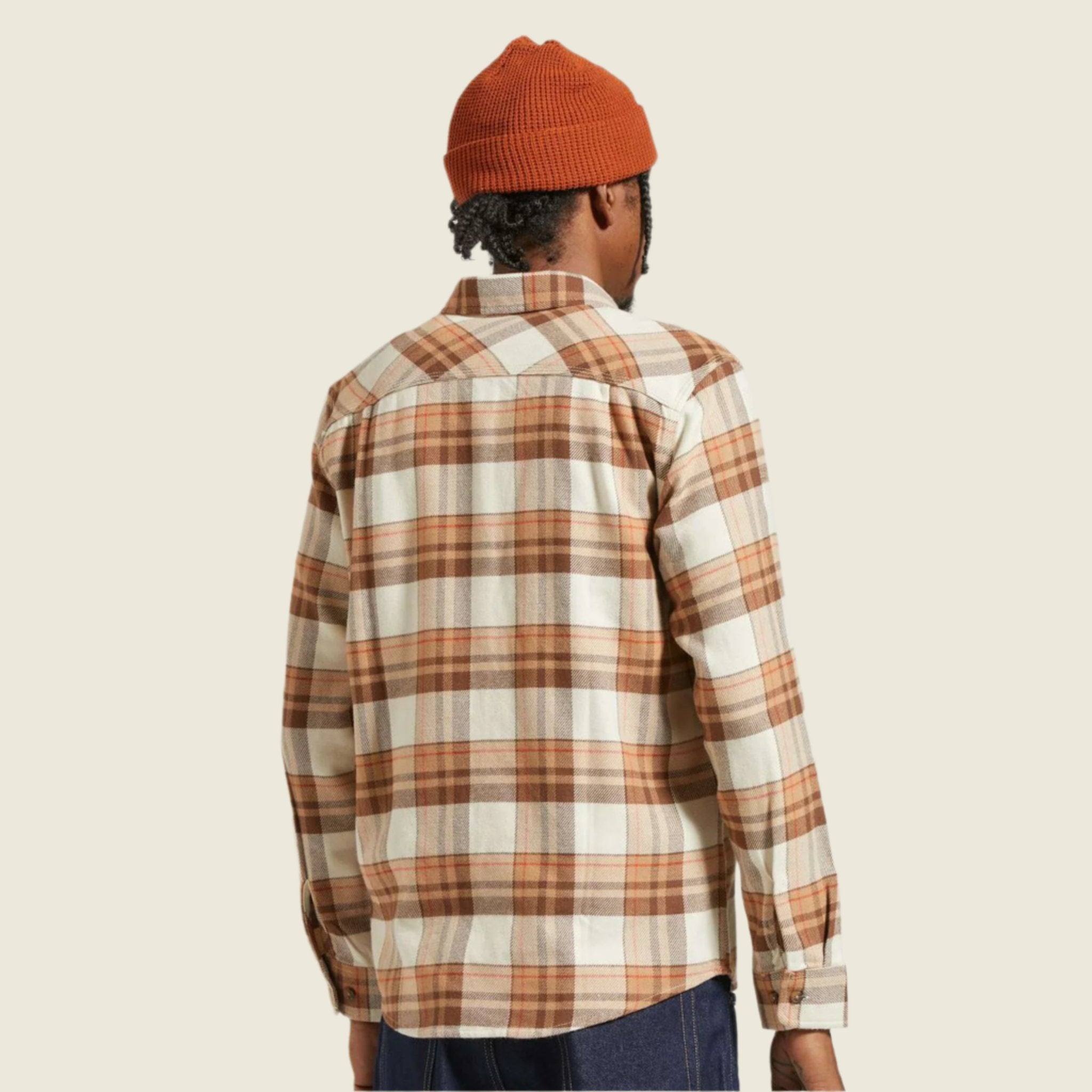 A tan, cream and brown plaid flannel shirt for men. 
