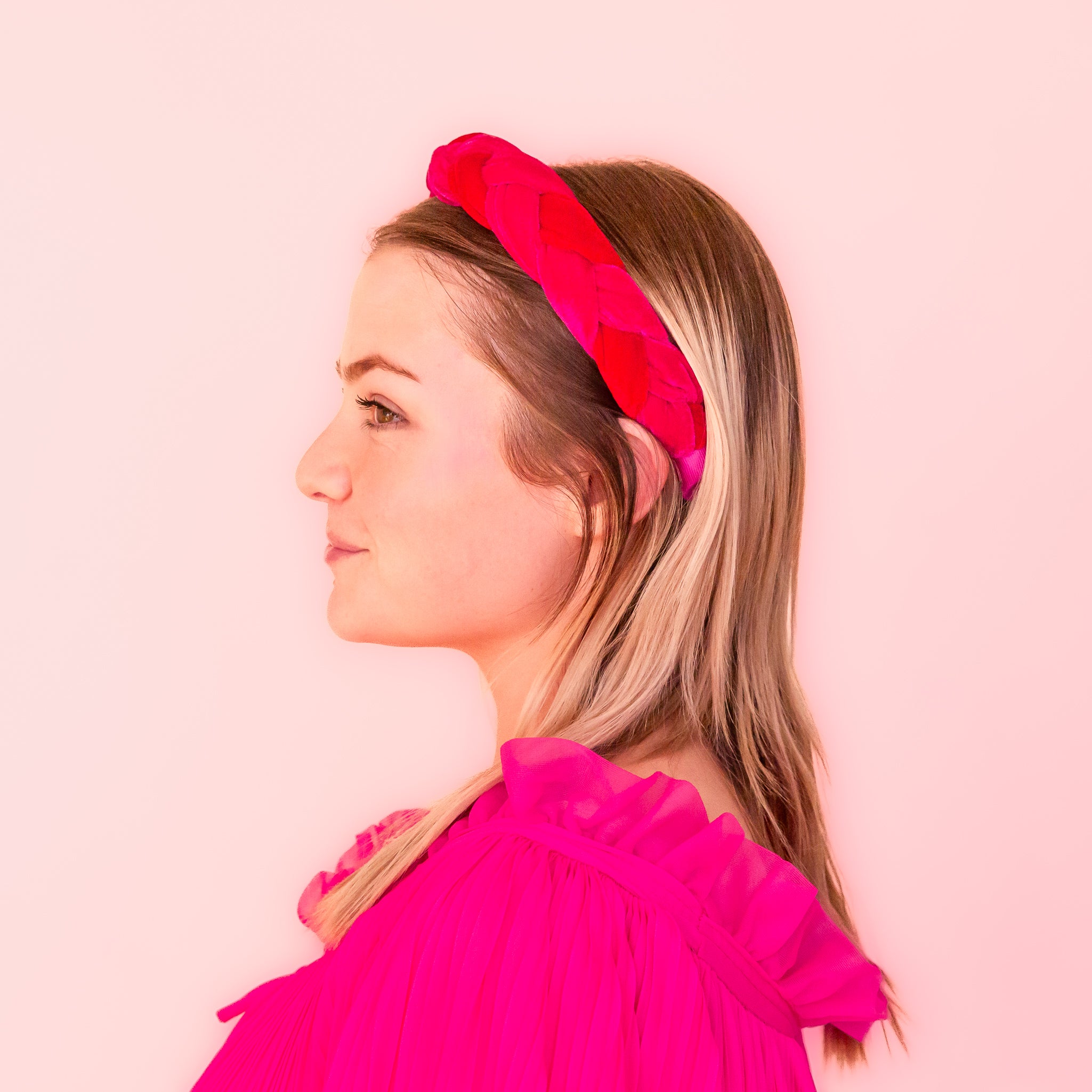 A red and pink braided headband. 