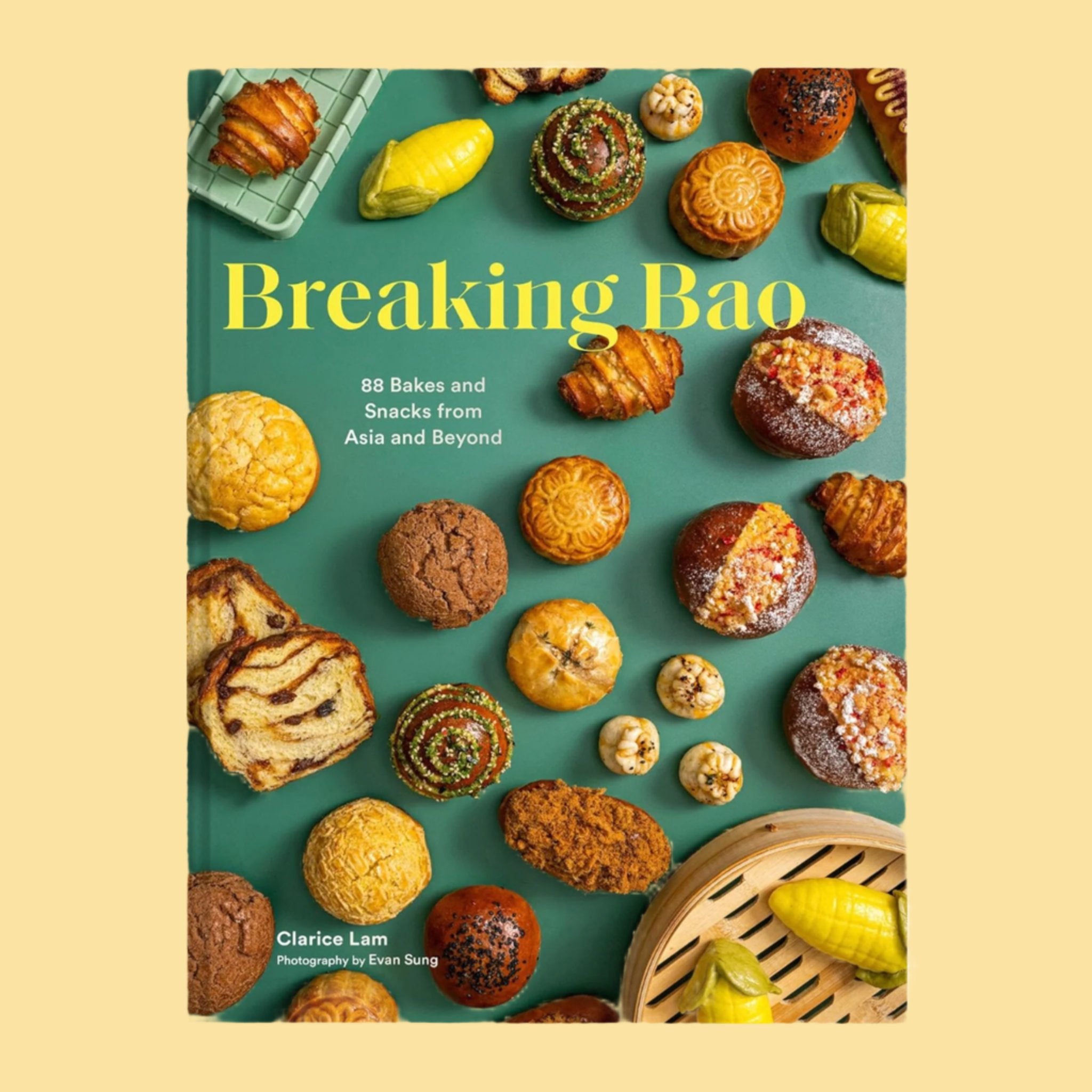 A green book cover with a variety of Asian snacks and baking items with text that reads, 'Breaking Bao'.