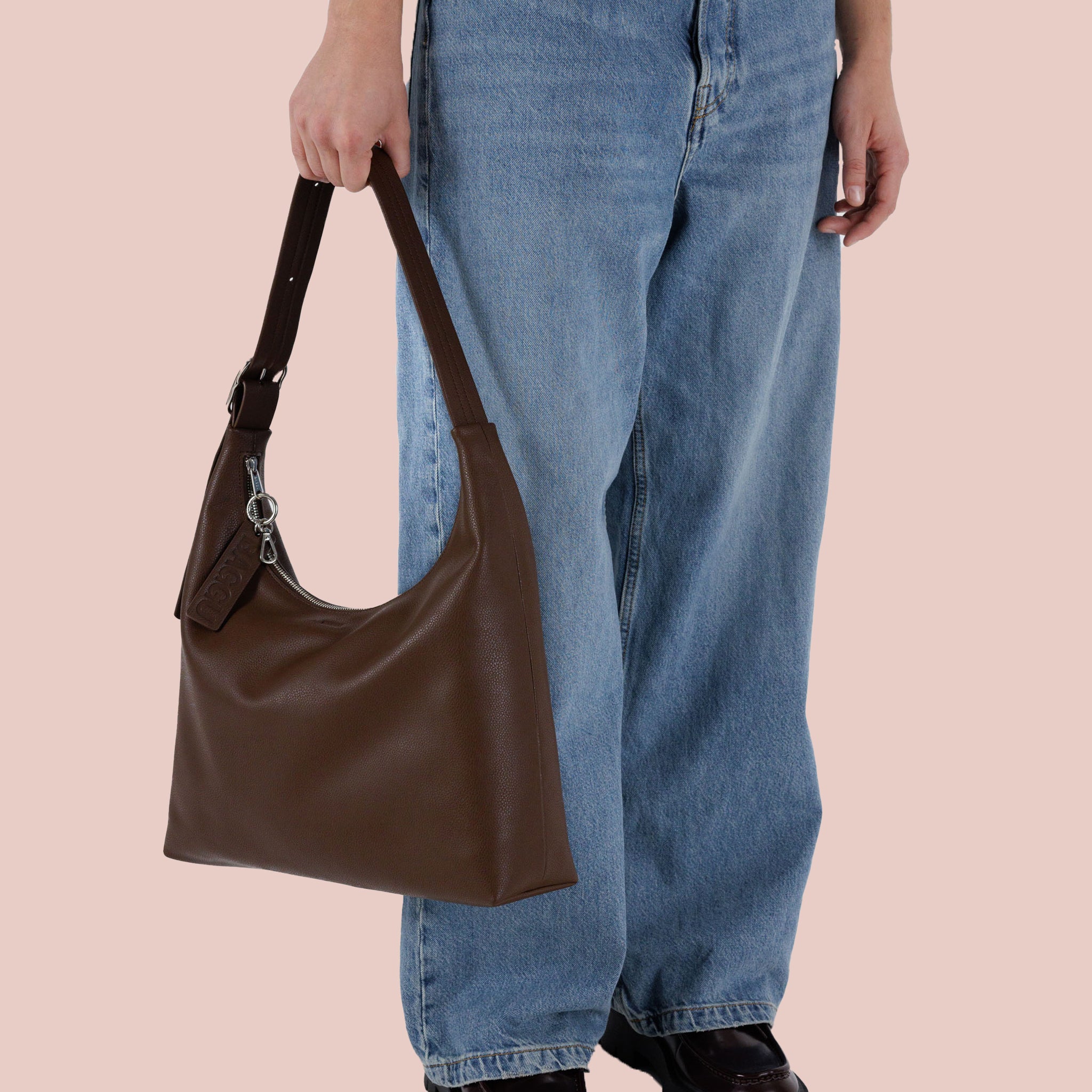 A brown leather shoulder handbag. 