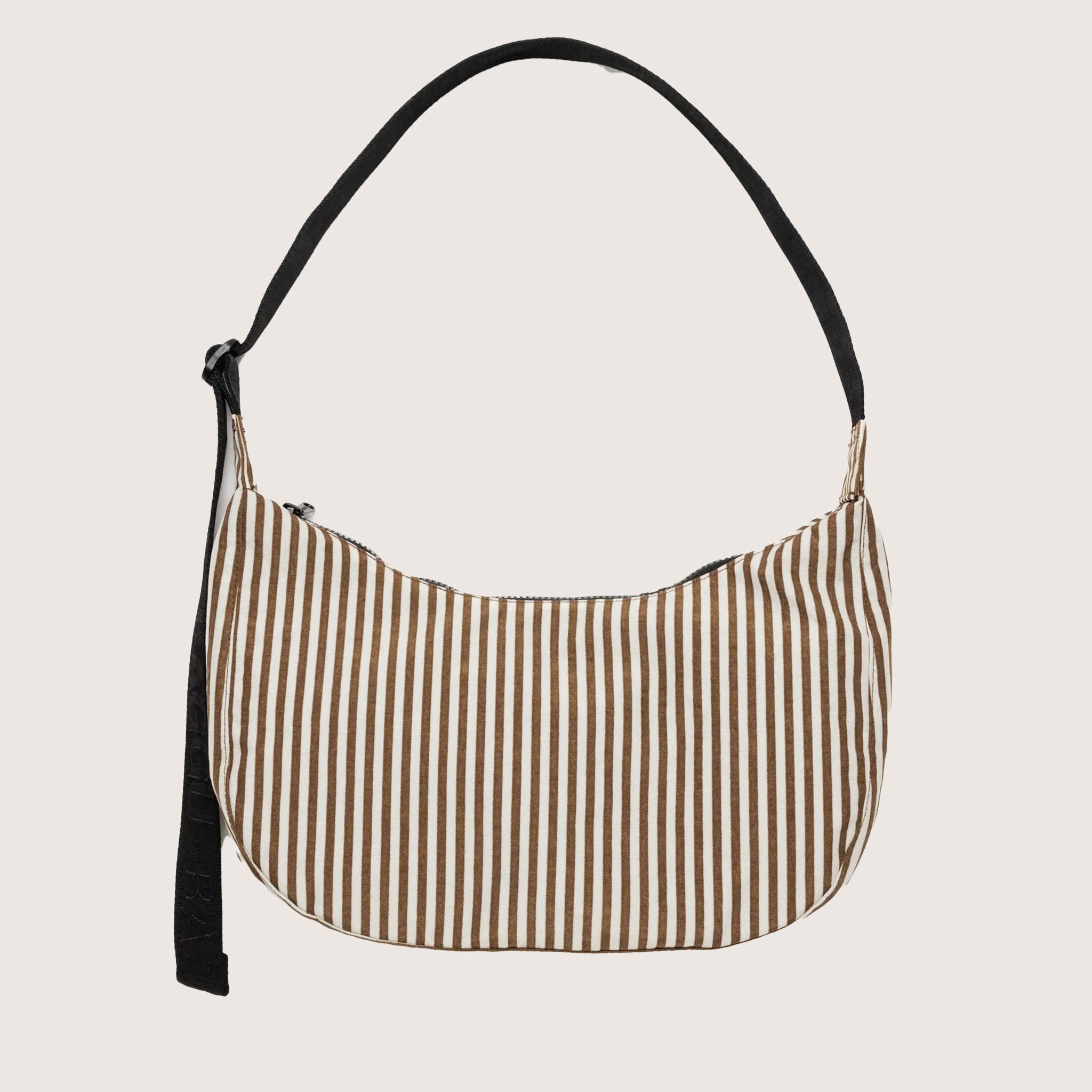 A brown and ivory striped crescent shaped bag with a black adjustable strap. 