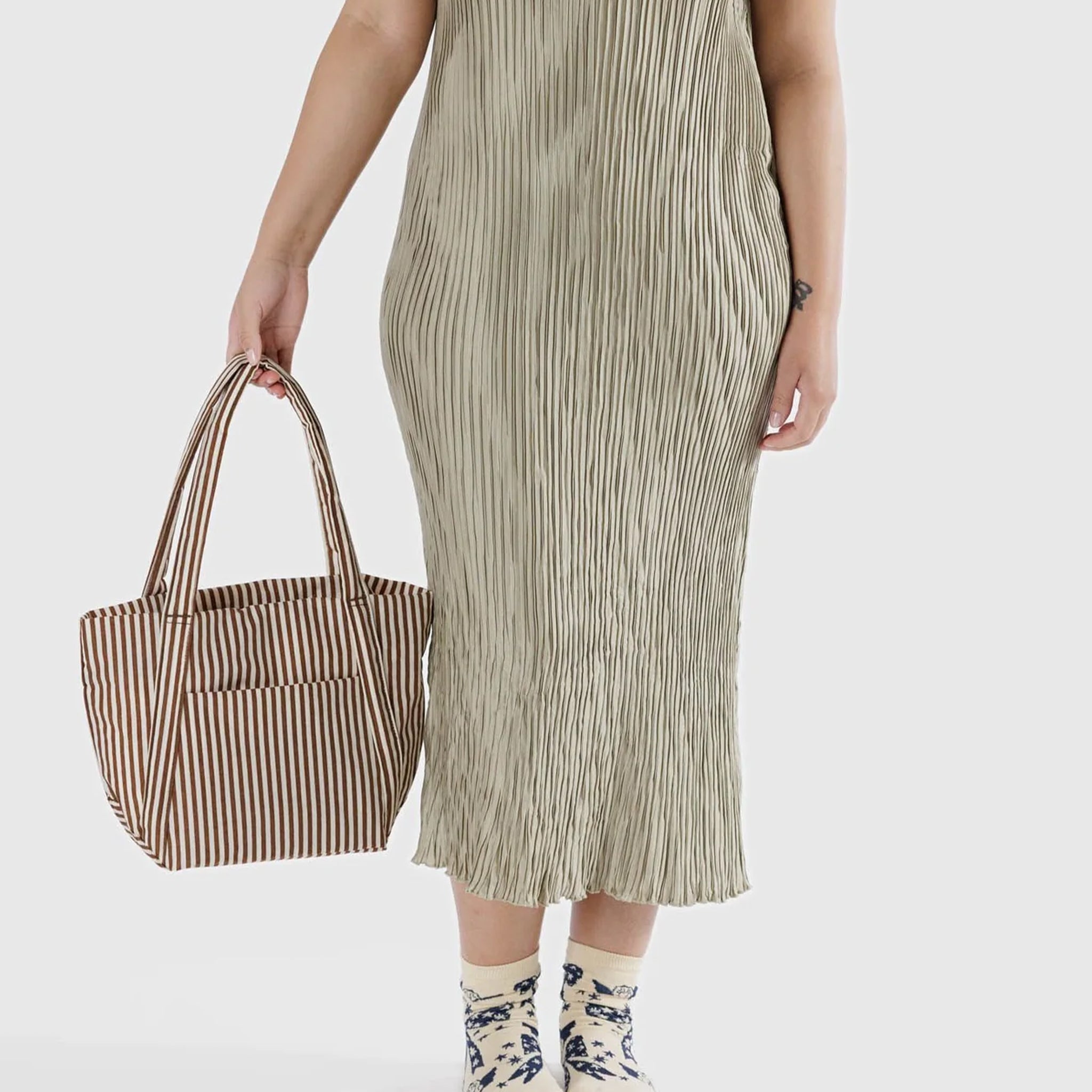A brown and white stripe nylon tote bag with shoulder handles and a front pocket.