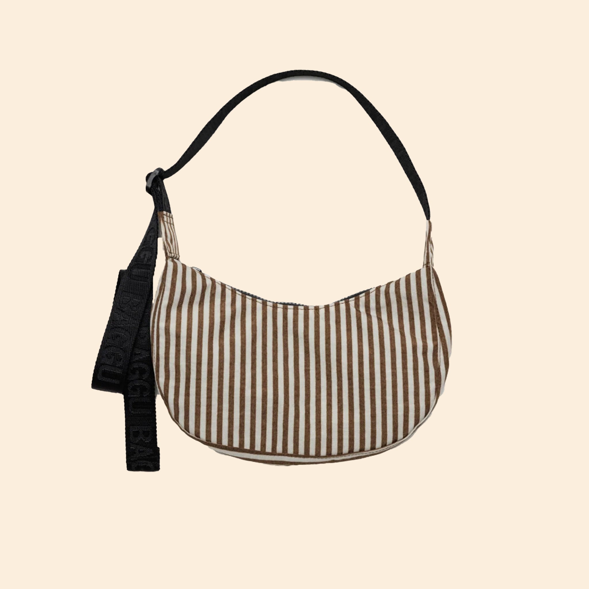 An ivory and browns striped nylon handbag with a black strap. 