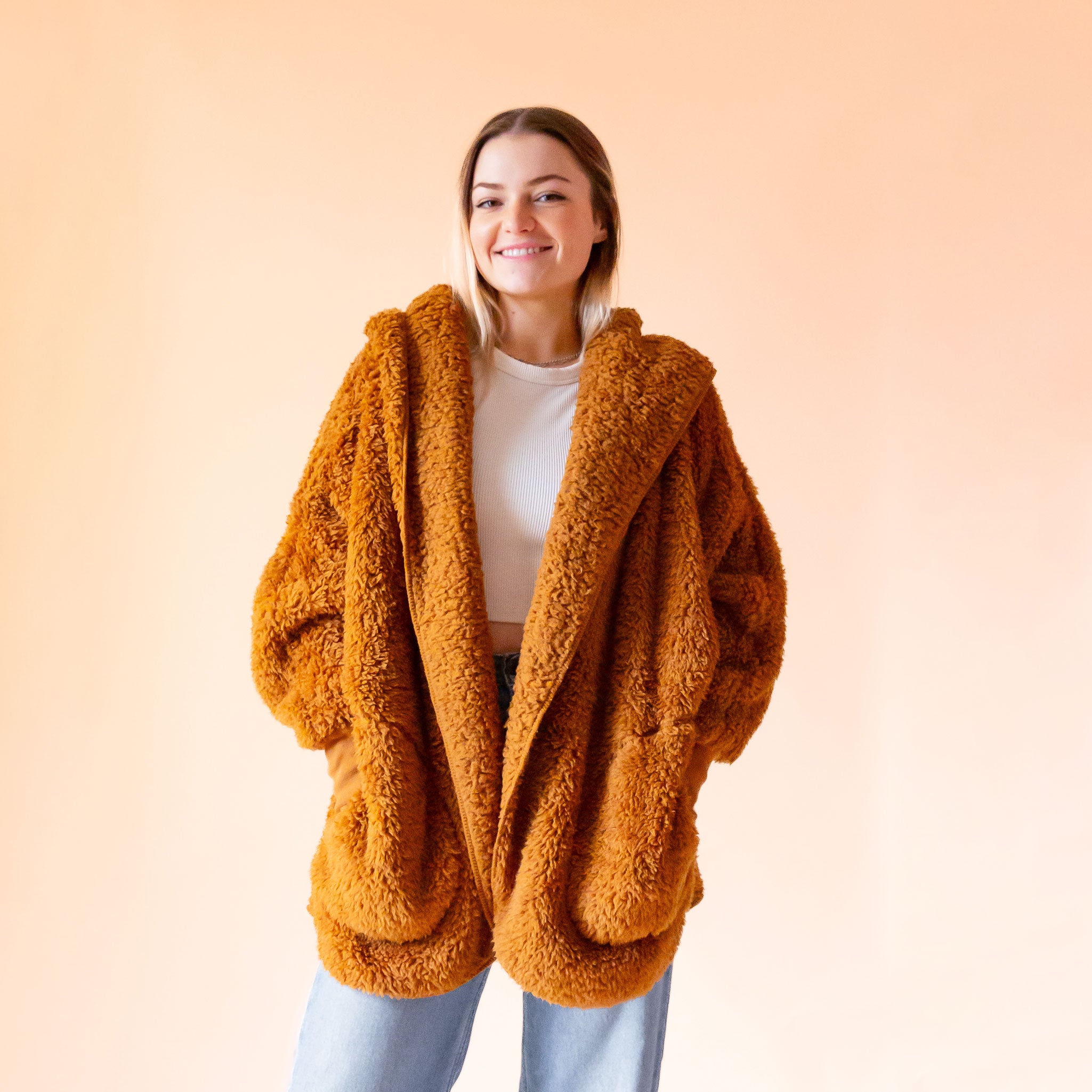 A butterscotch brownish orange fuzzy sweater. 