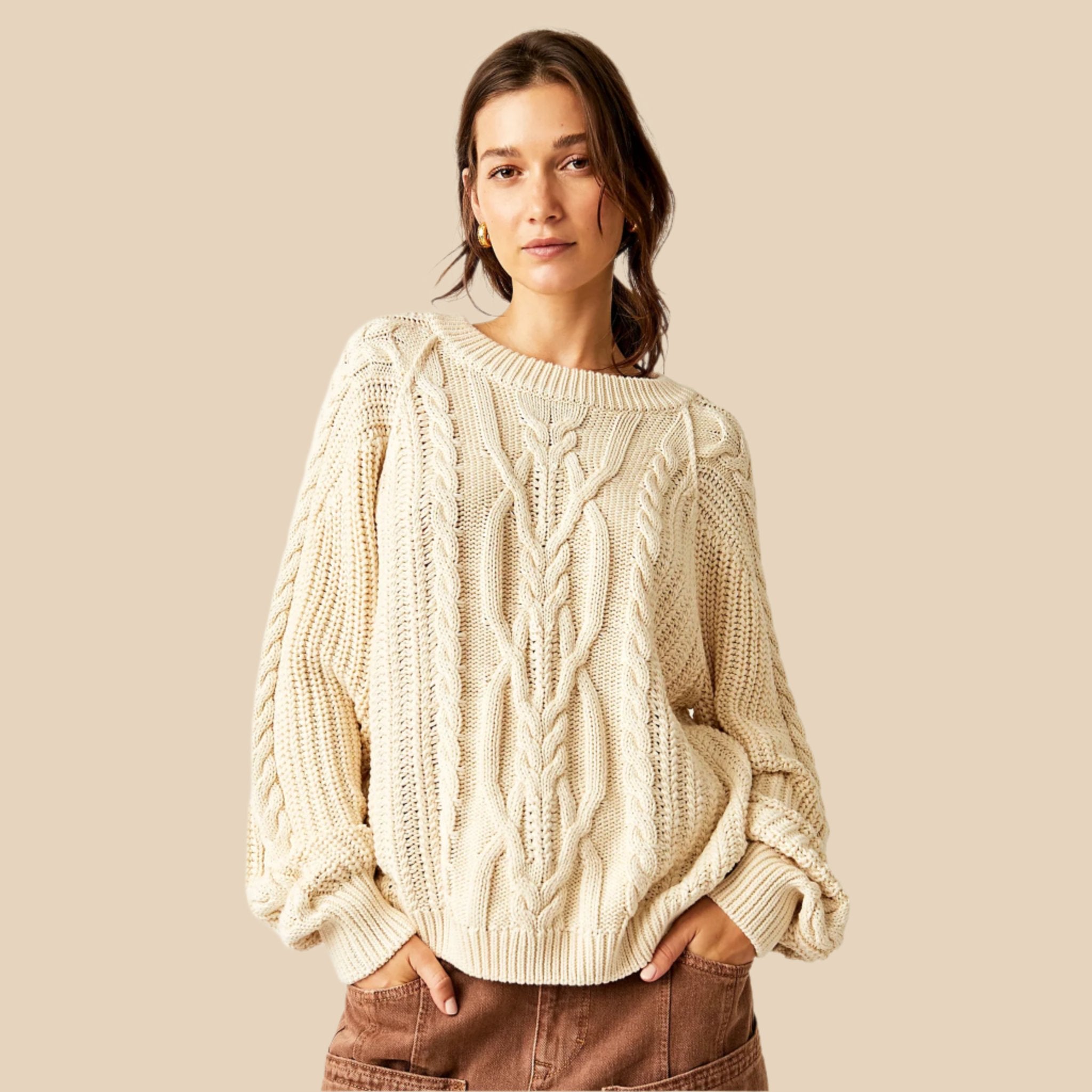 An ivory slouchy fit cable knit sweater. 