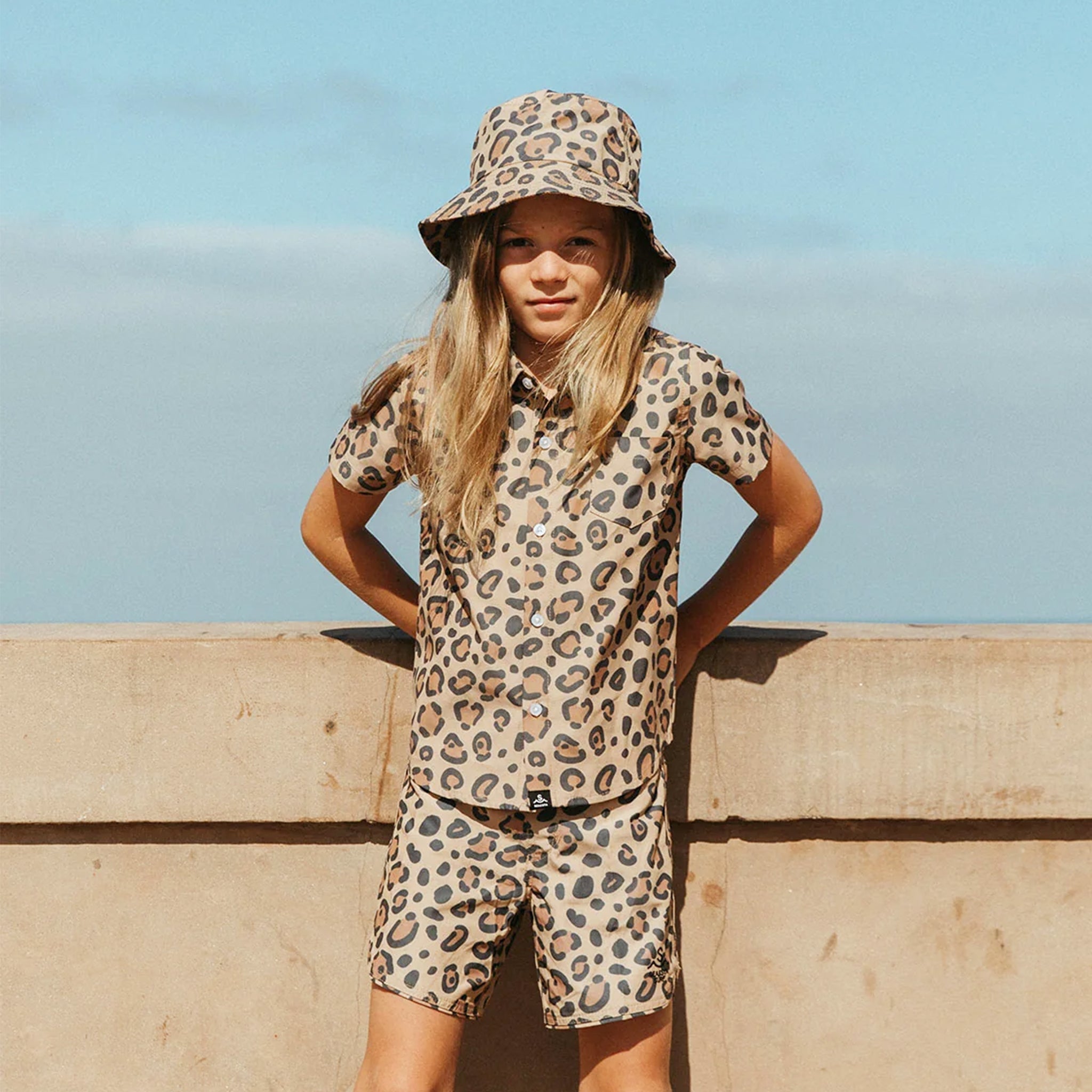 A black and brown leopard print boardshorts. 