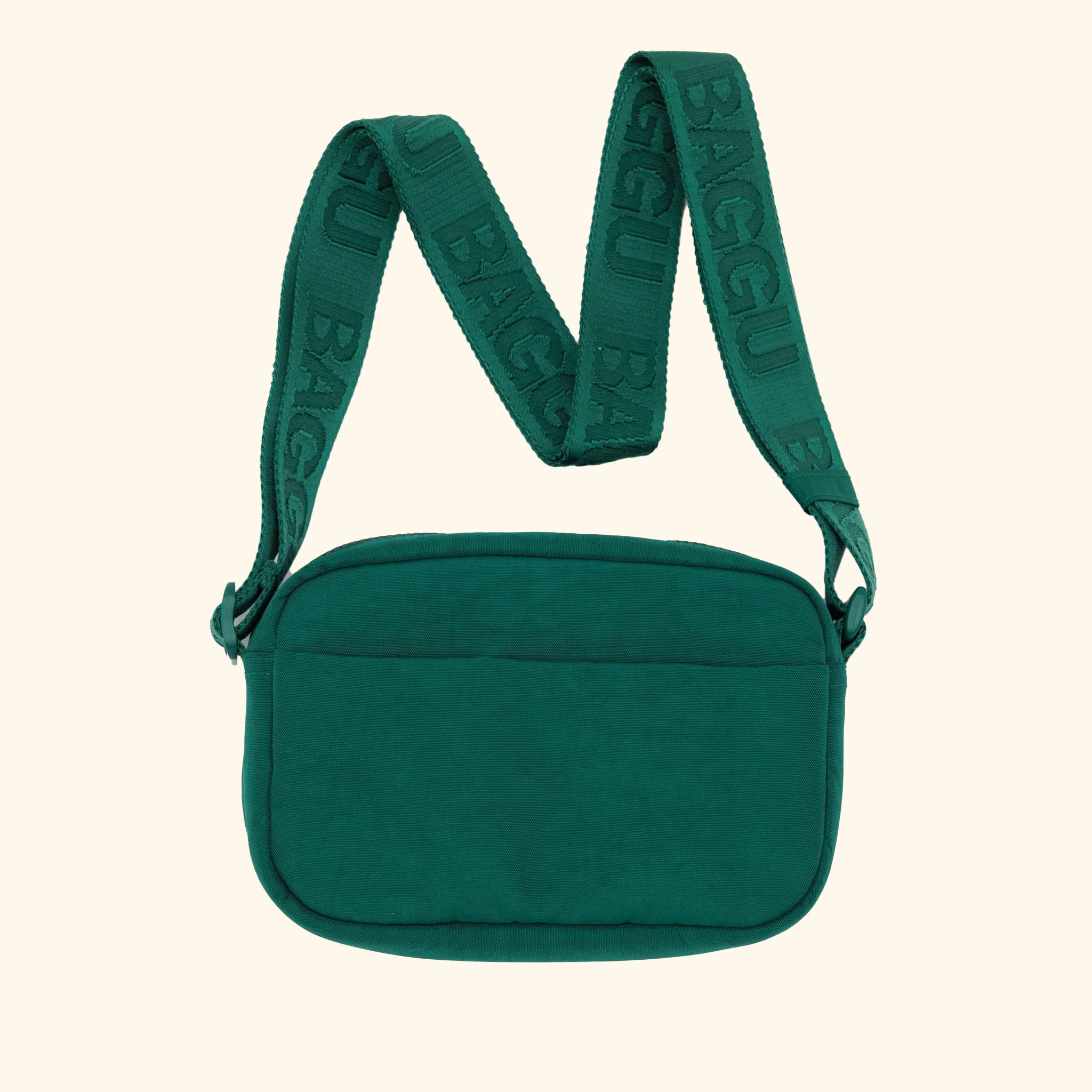 A green crossbody bag made of nylon with an adjustable strap. 