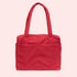 A red small carry on tote bag with two handle straps, front pockets and a zipper closure. 