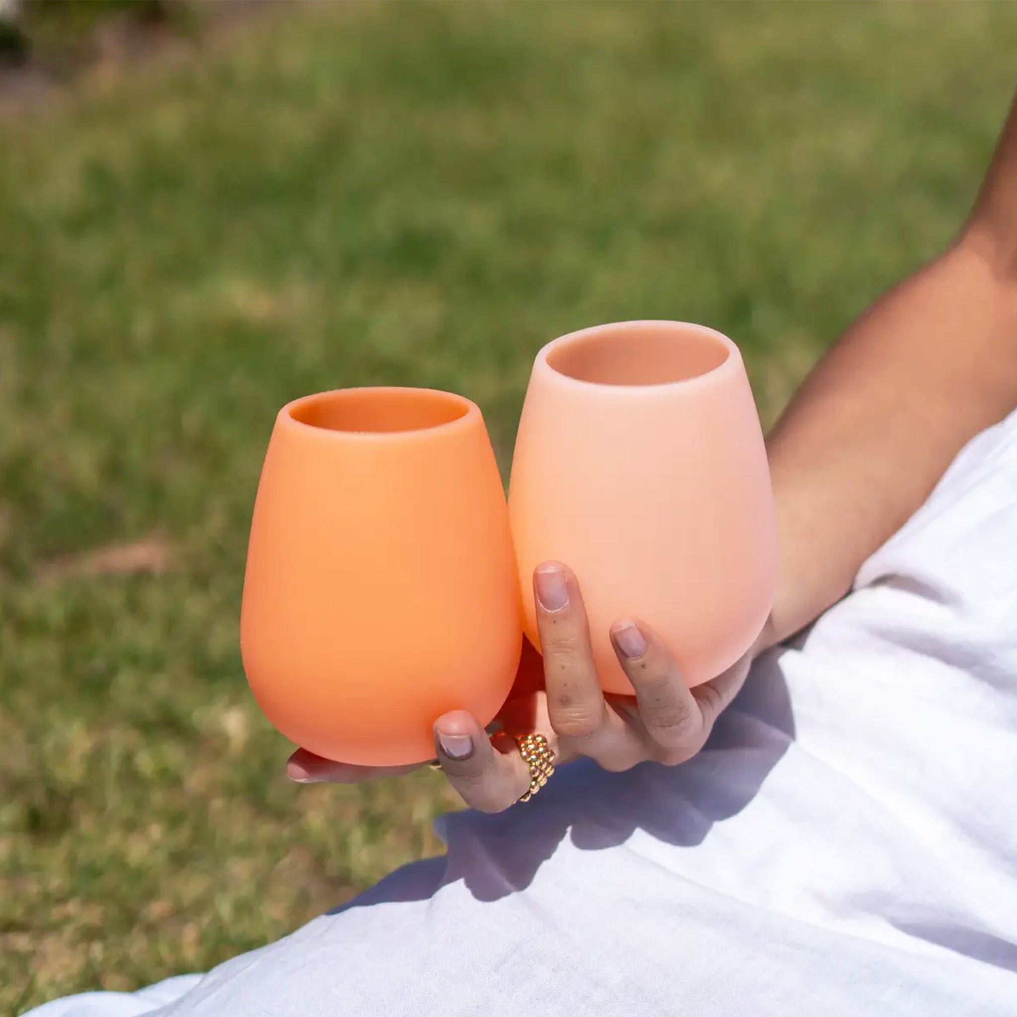 Two silicone stemless cups in two shades of orange and apricot. 
