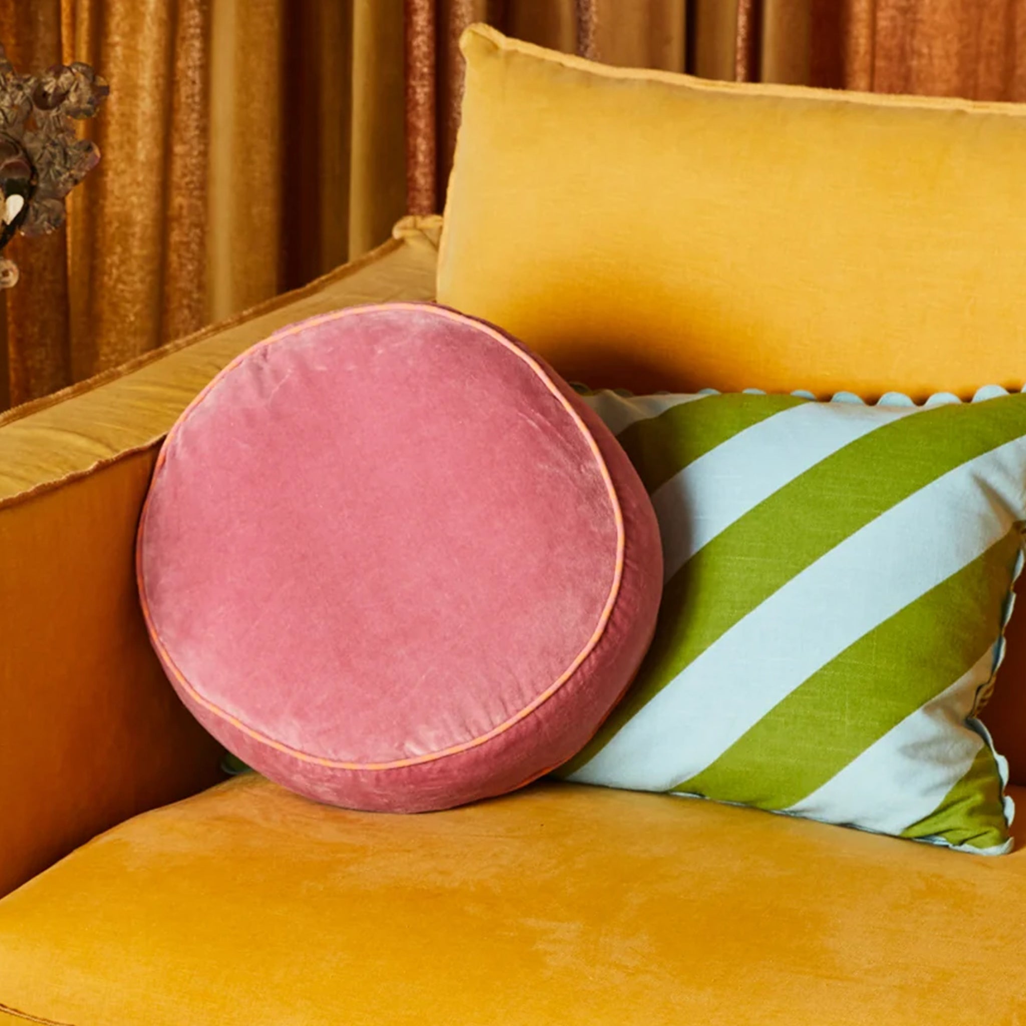 A round pink pillow. 