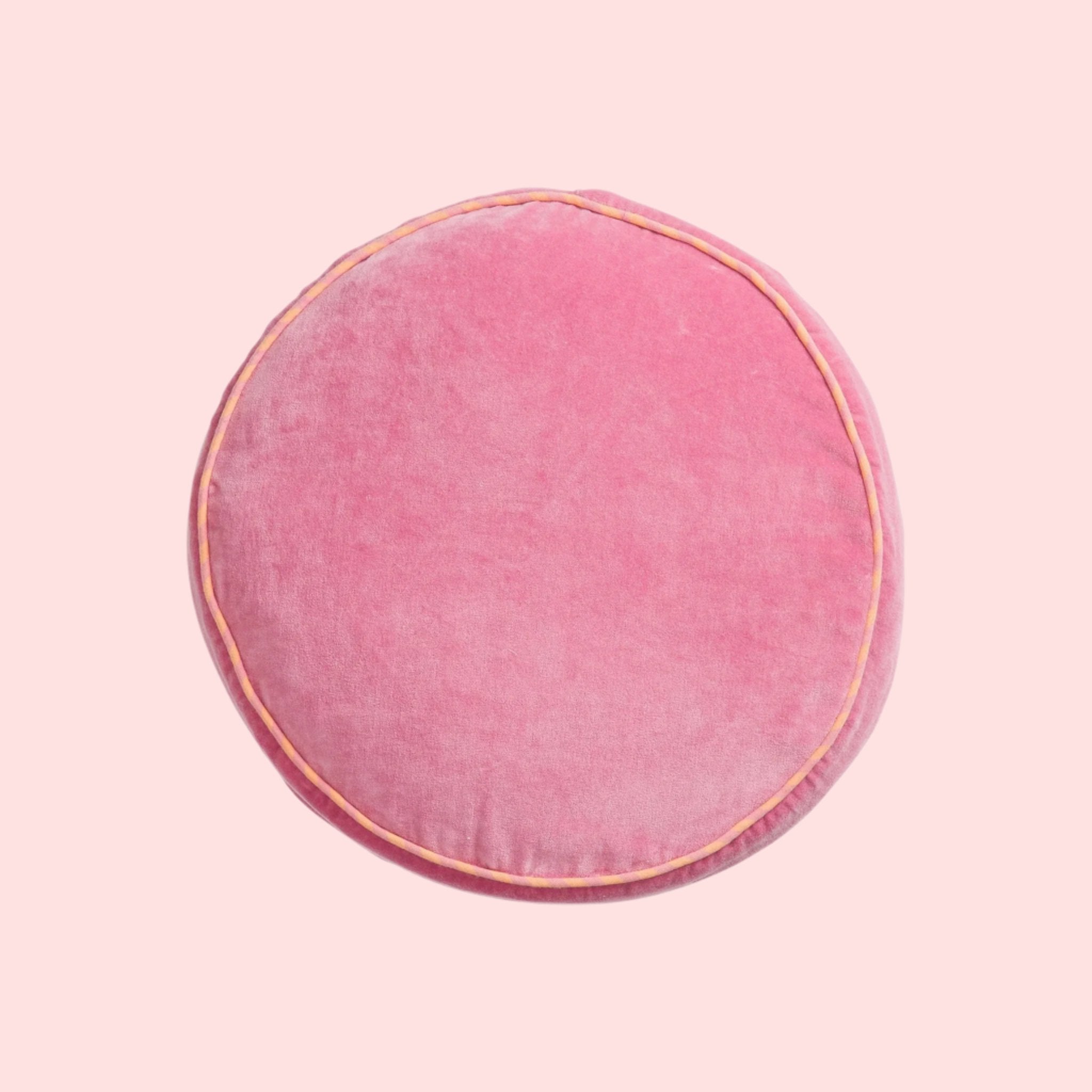 A round pink pillow. 