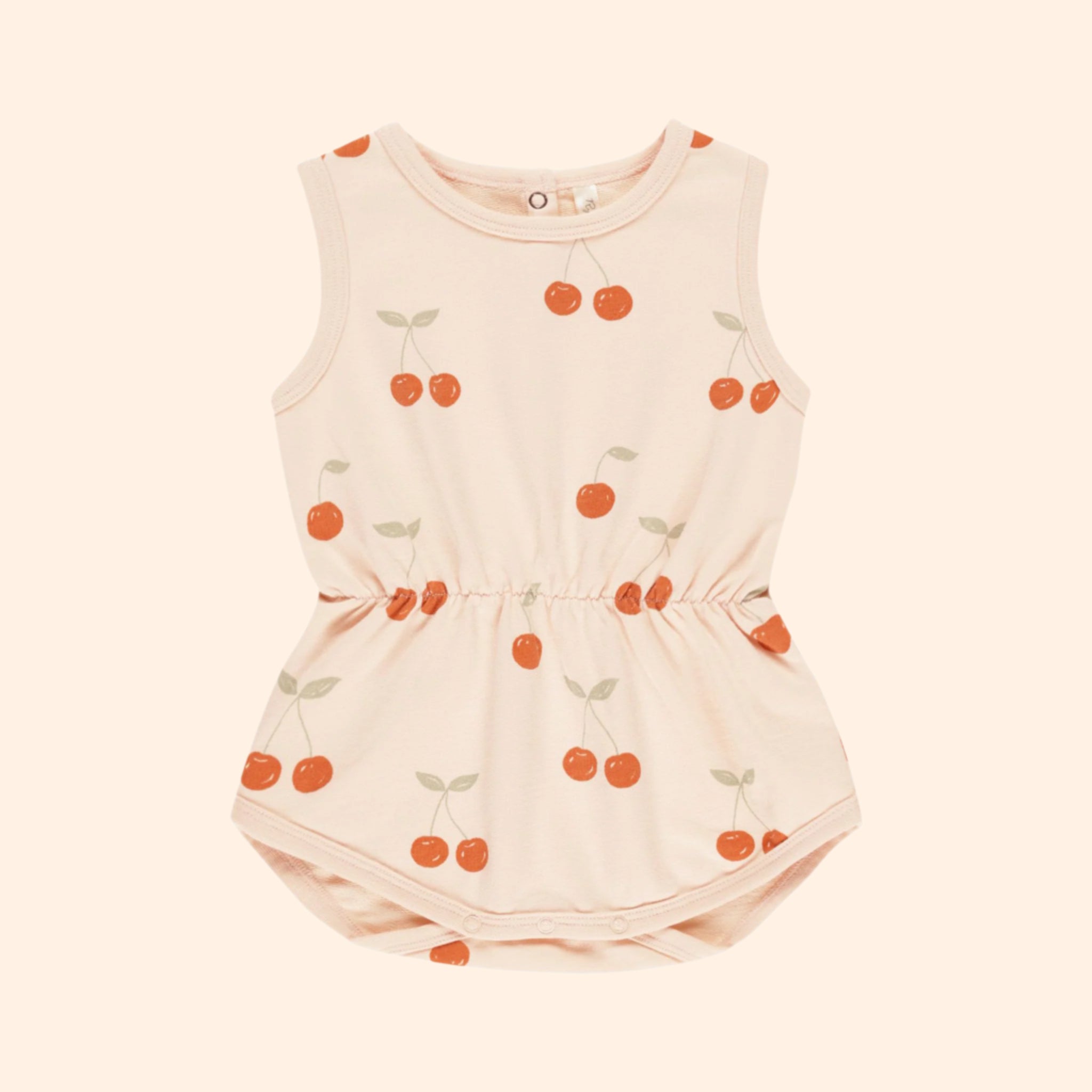 A light pink / peach colored jumpsuit with short sleeves and a cherry print. 