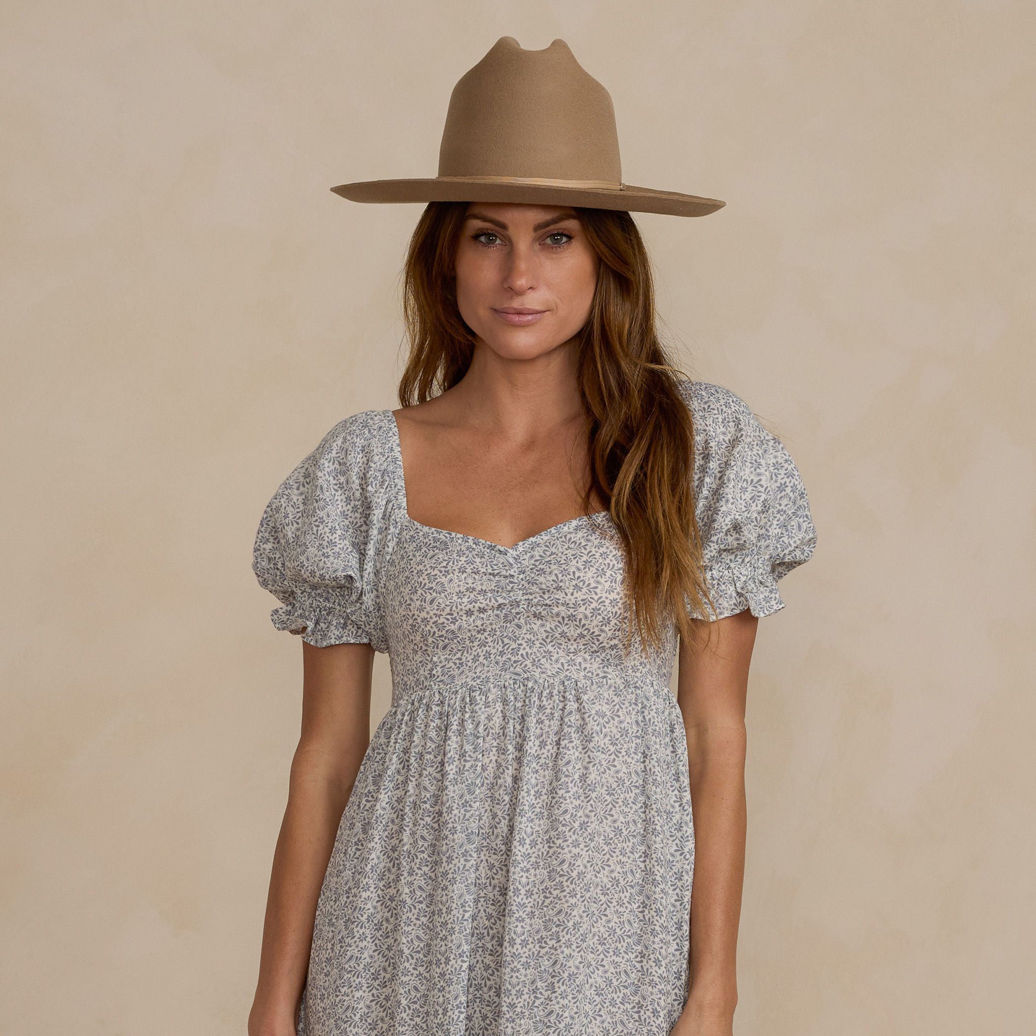 A light blue floral dress with a square neckline and puff sleeves.