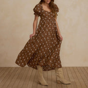 A brown floral maxi dress with puff sleeves.