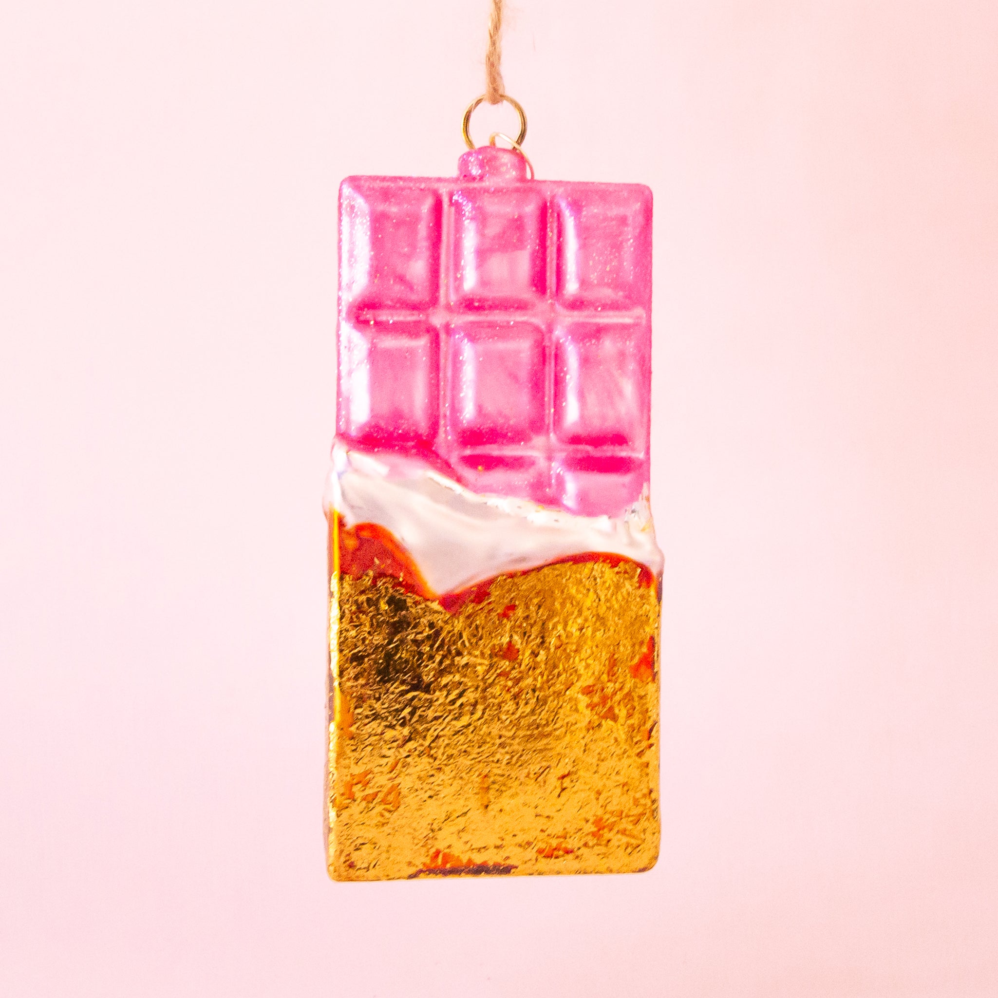 A pink and gold glass shaped chocolate bar with the loop for hanging. 