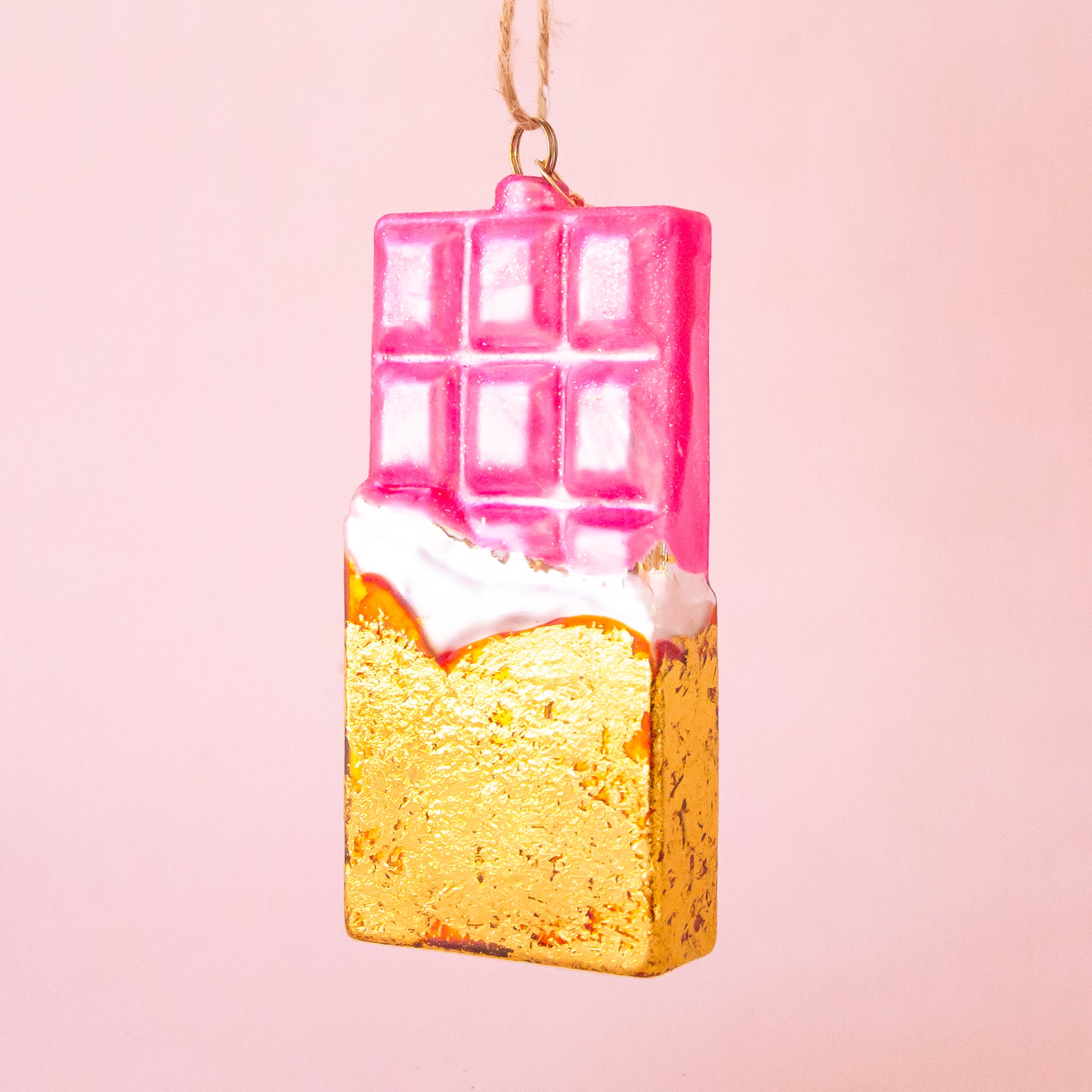 A pink and gold glass shaped chocolate bar with the loop for hanging. 