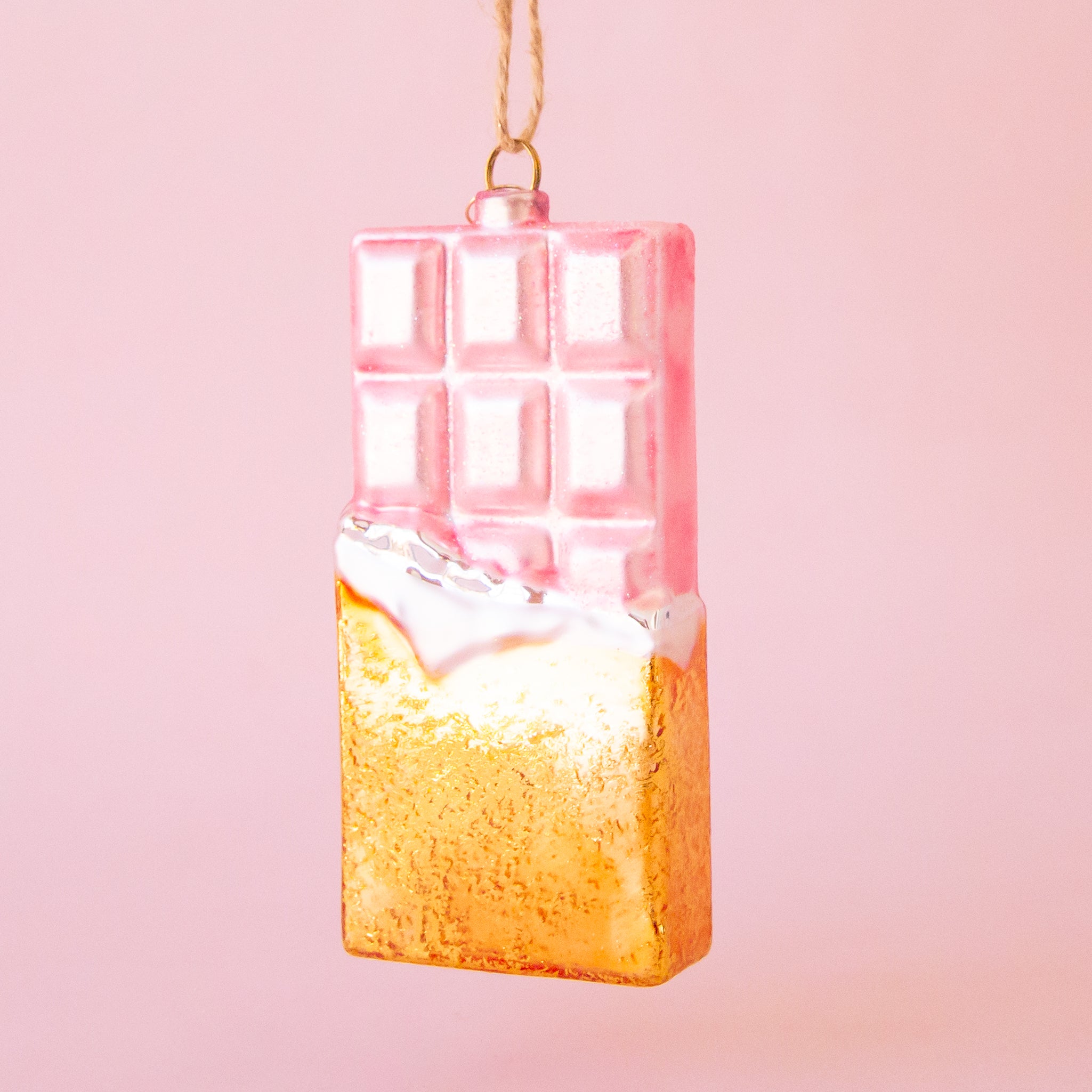 A light pink and gold chocolate bar shaped ornament. 