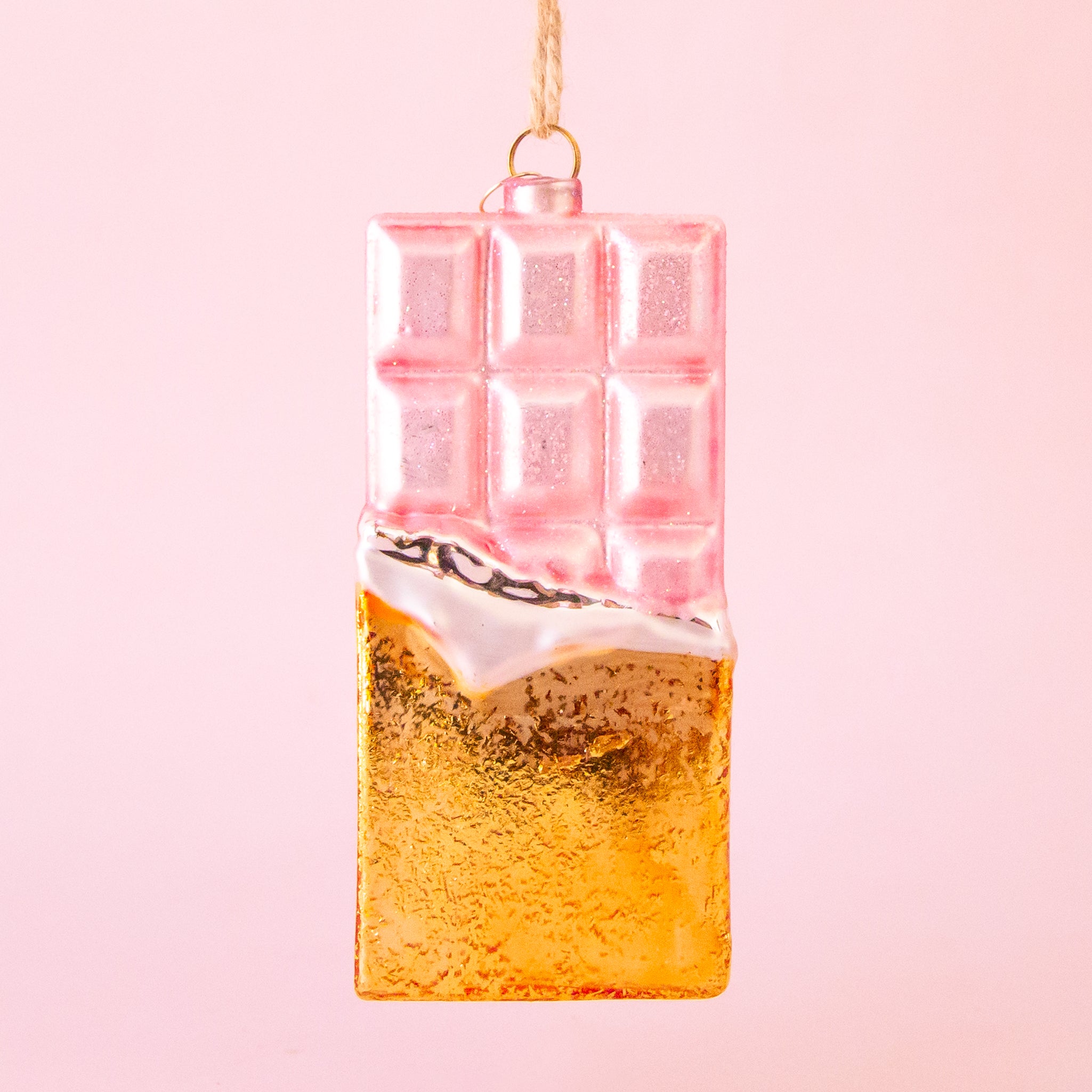 A light pink and gold chocolate bar shaped ornament. 