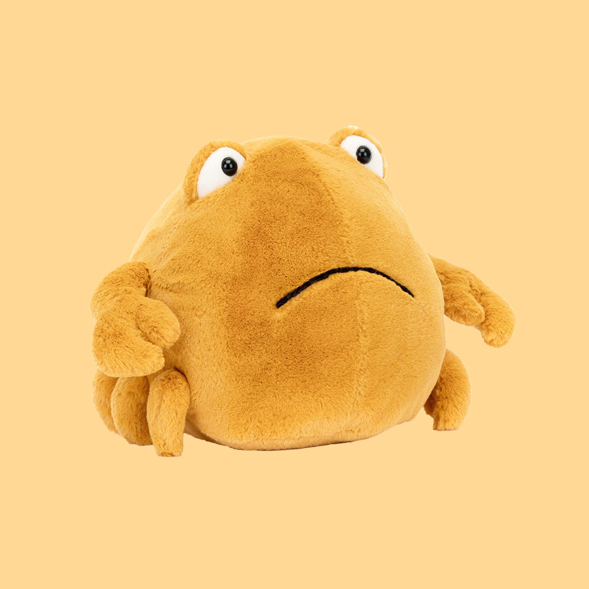 A yellow crab shaped stuffed animal. 