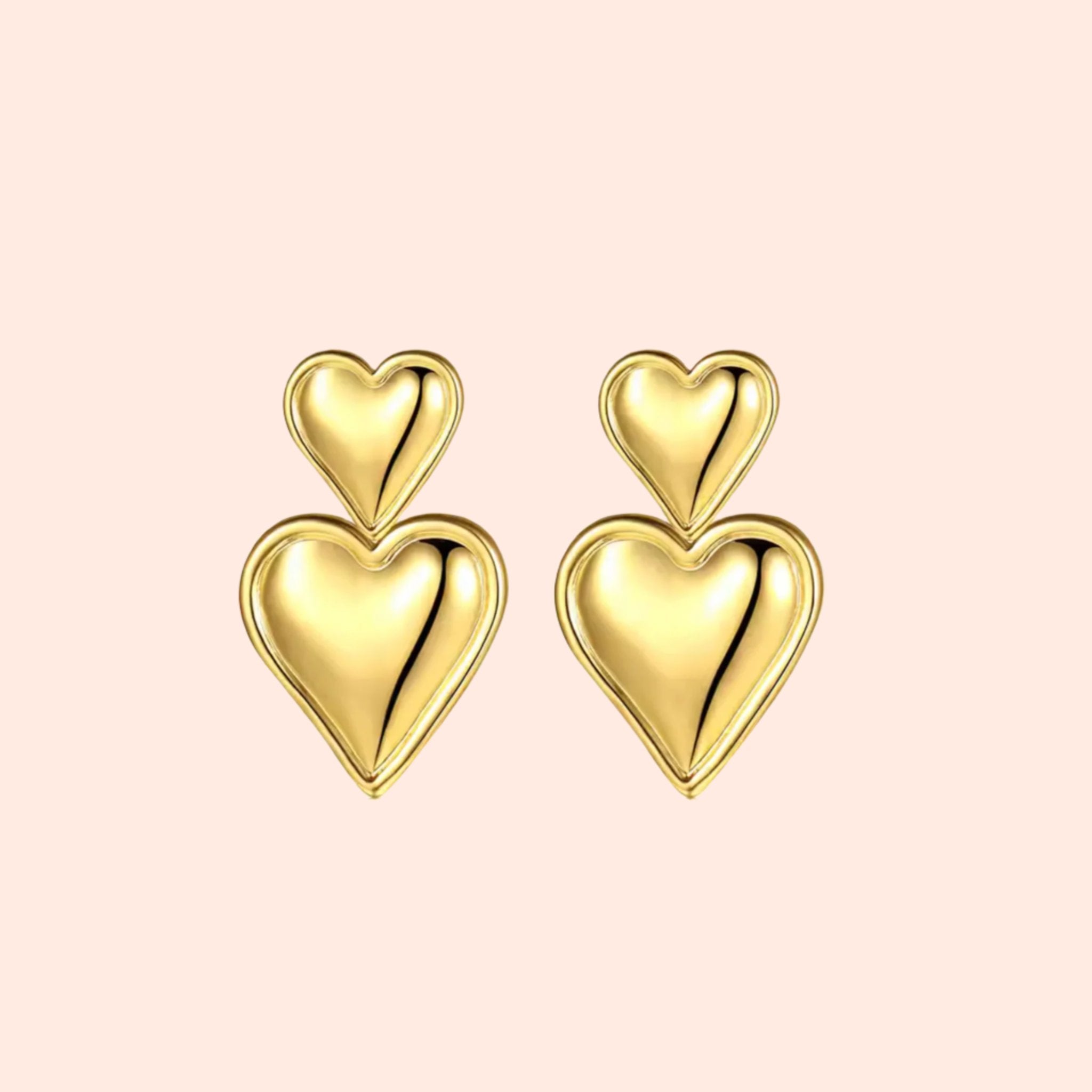 A pair of gold double heart earrings. 