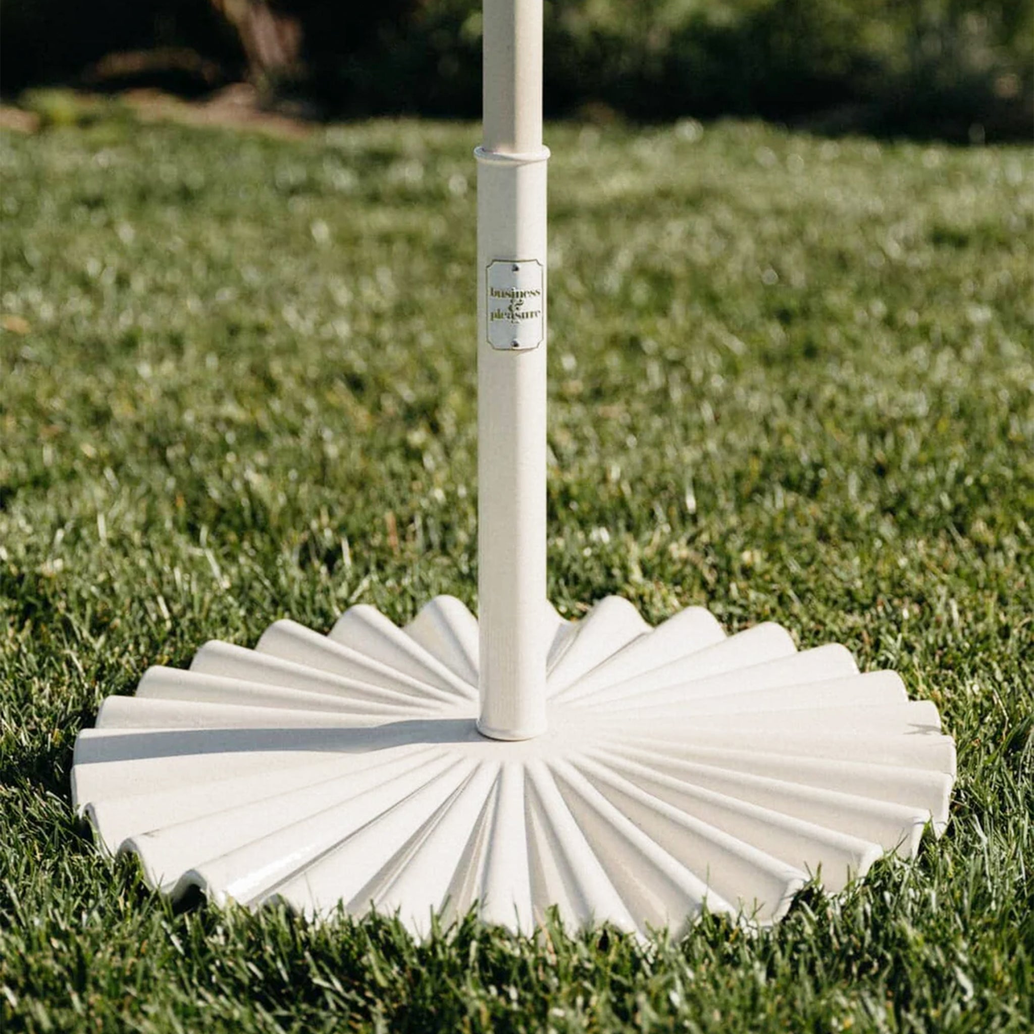 A wavy umbrella base in an antique white color. 