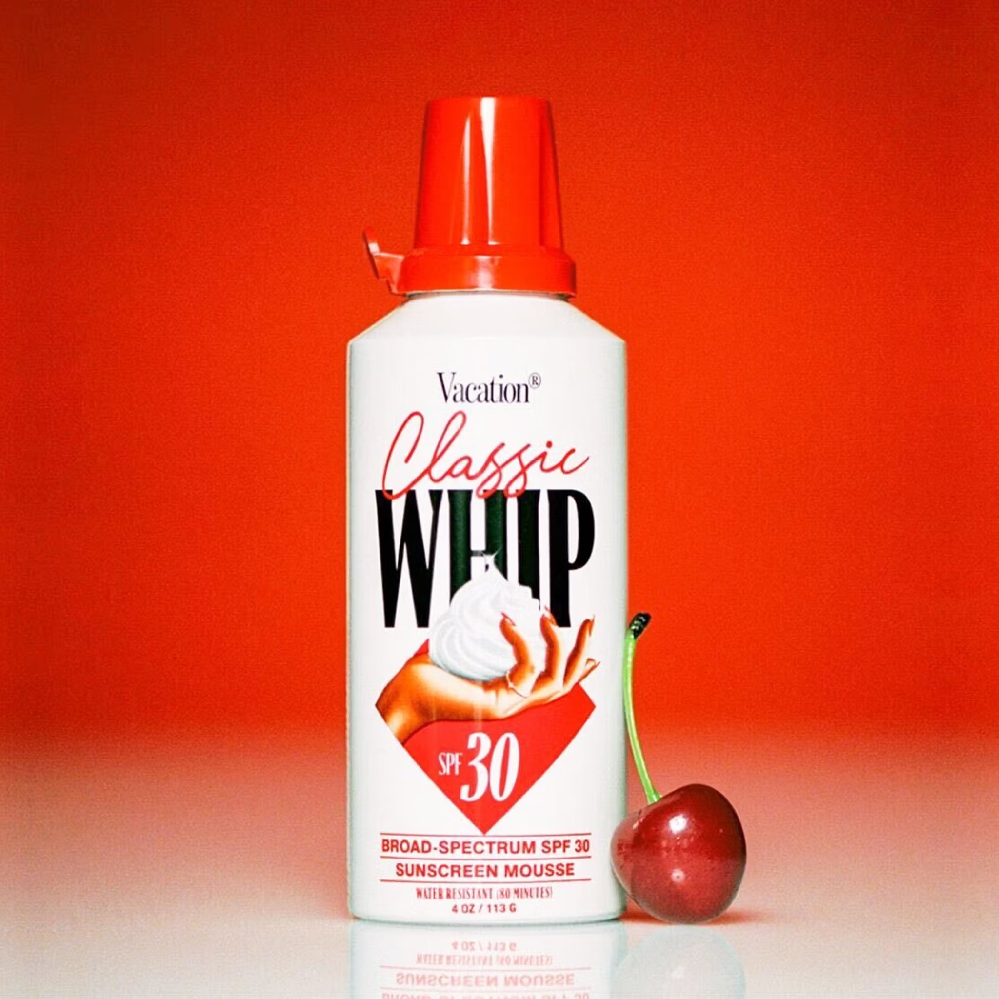 An SPF that looks like a can of whipped cream with a white can that says, "Classic Whip SPF 30" along with a red cap and accents.