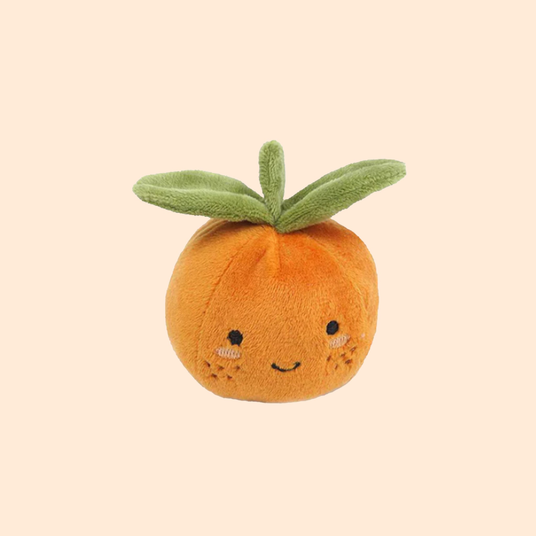 An orange clementine shaped stuffed toy. 