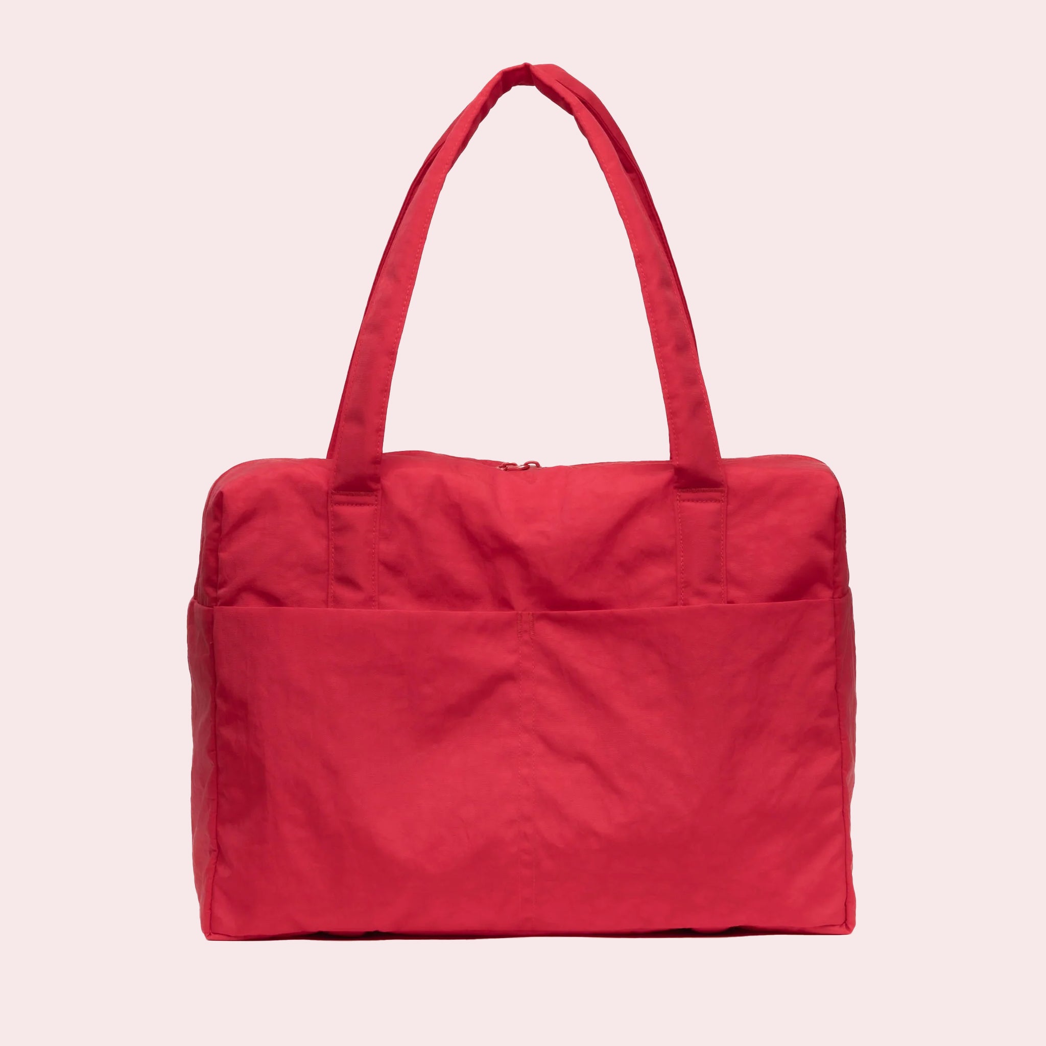 A red nylon carry on tote bag with two handles and a zipper top. 