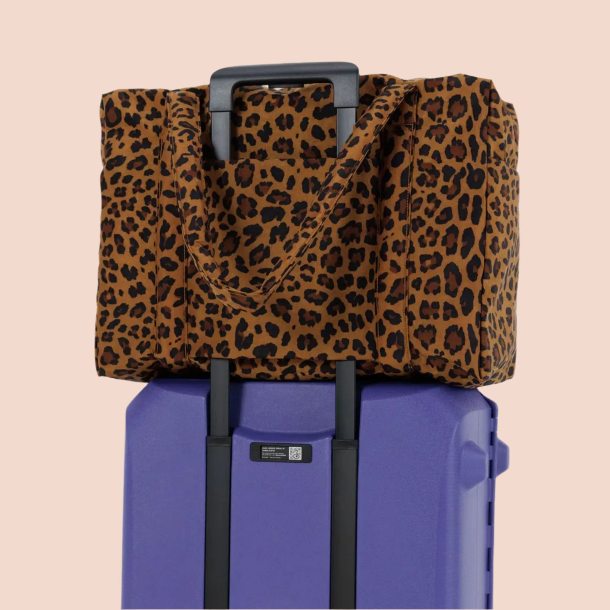 A brown and black leopard printed puffer carry on tote bag. 