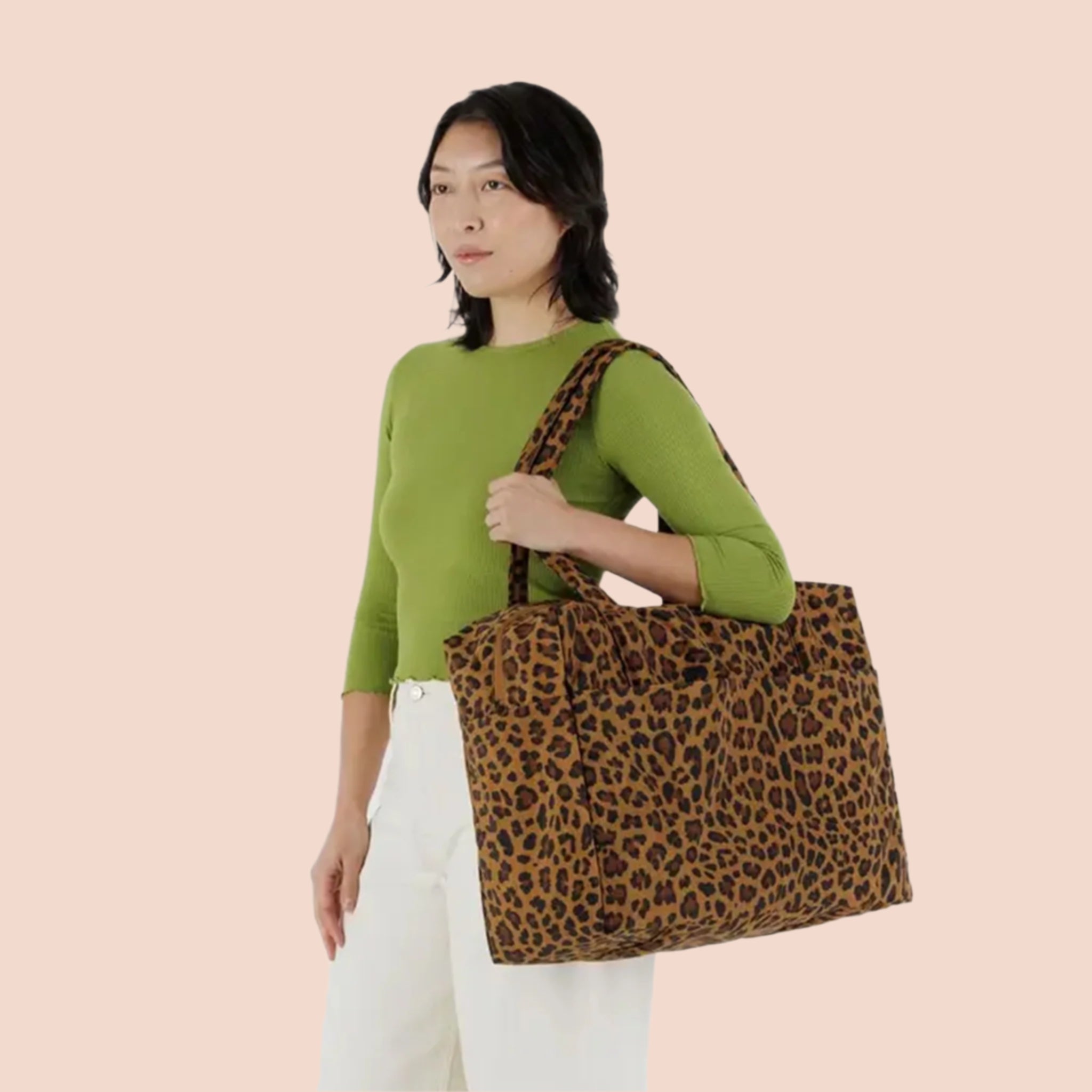 A brown and black leopard printed puffer carry on tote bag. 