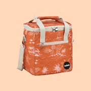 An orange mini cooler bag with a coastal pattern and ivory canvas straps and handles. 