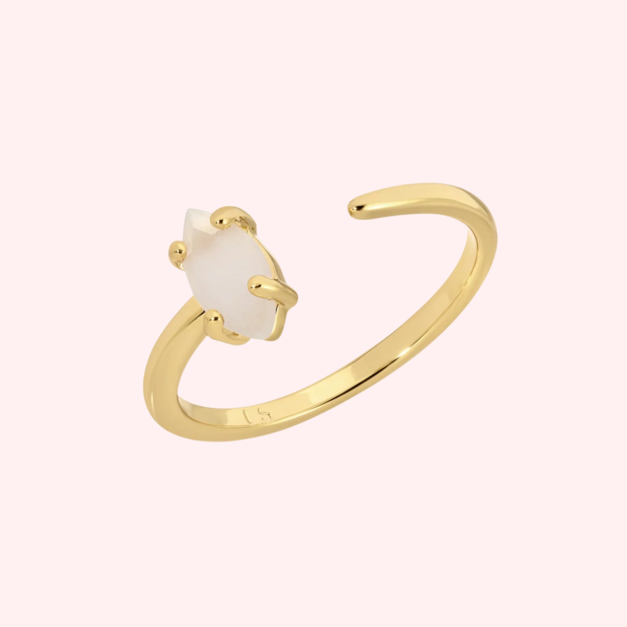 A gold ring with an open center and a marquise shaped stone on one side. 