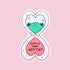 A pink heart shaped compact sticker with a green frog in the reflection and text that reads, 'Who Is That Hottie?'.